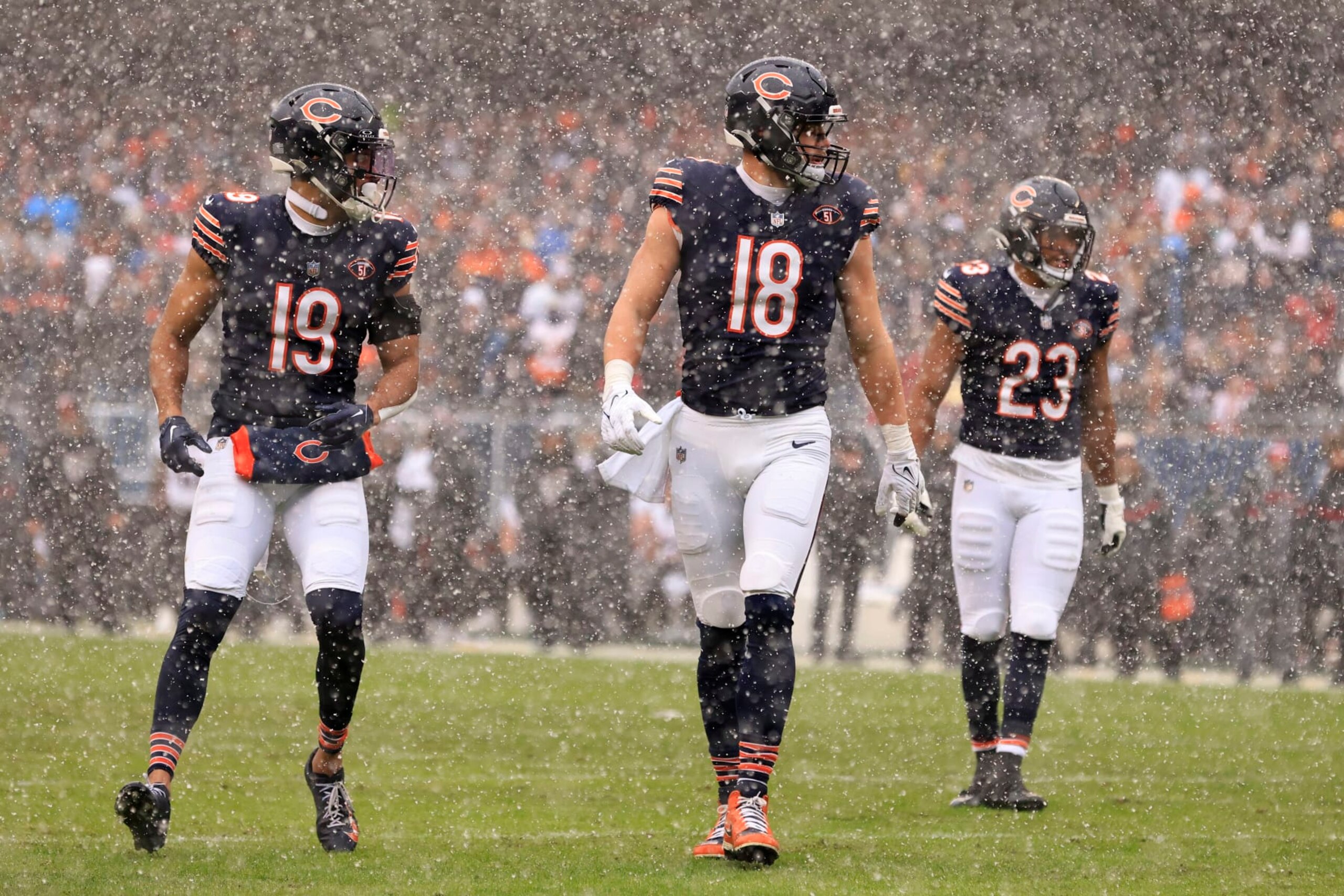 CHICAGO, ILLINOIS - DECEMBER 31: Equanimeous St. Brown #19, Robert Tonyan #18 and Roschon Johnson #23 of the Chicago Bears line up in the game against the Atlanta Falcons at Soldier Field on December 31, 2023 in Chicago, Illinois. (Photo by Justin Casterline/Getty Images)