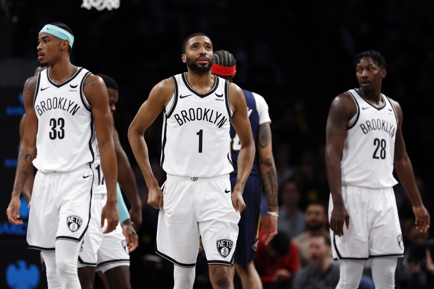 NEW YORK, NEW YORK - MARCH 19: Nic Claxton #33, Mikal Bridges #1, and Dorian Finney-Smith #28 of the Brooklyn Nets look on during the second half against the New Orleans Pelicans at Barclays Center on March 19, 2024 in the Brooklyn borough of New York City. NOTE TO USER: User expressly acknowledges and agrees that, by downloading and/or using this Photograph, user is consenting to the terms and conditions of the Getty Images License Agreement. (Photo by Sarah Stier/Getty Images)