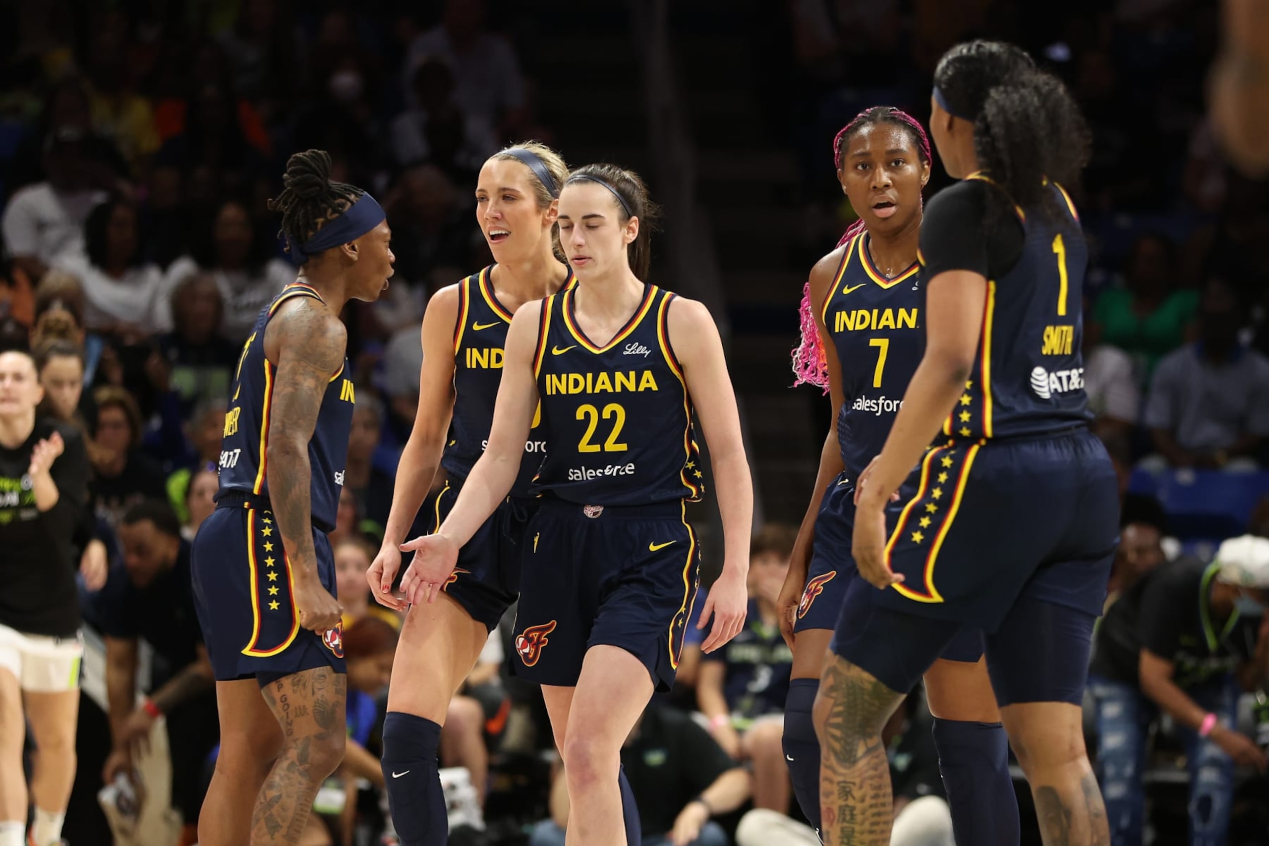 ARLINGTON, TEXAS - MAY 03: Caitlin Clark #22 of the Indiana Fever celebrates with teammates while playing the Dallas Wings during a pre season game at College Park Center on May 03, 2024 in Arlington, Texas. (Photo by Gregory Shamus/Getty Images) ARLINGTON, TEXAS - MAY 03: Caitlin Clark #22 of the Indiana Fever celebrates with teammates while playing the Dallas Wings during a pre season game at College Park Center on May 03, 2024 in Arlington, Texas. (Photo by Gregory Shamus/Getty Images)