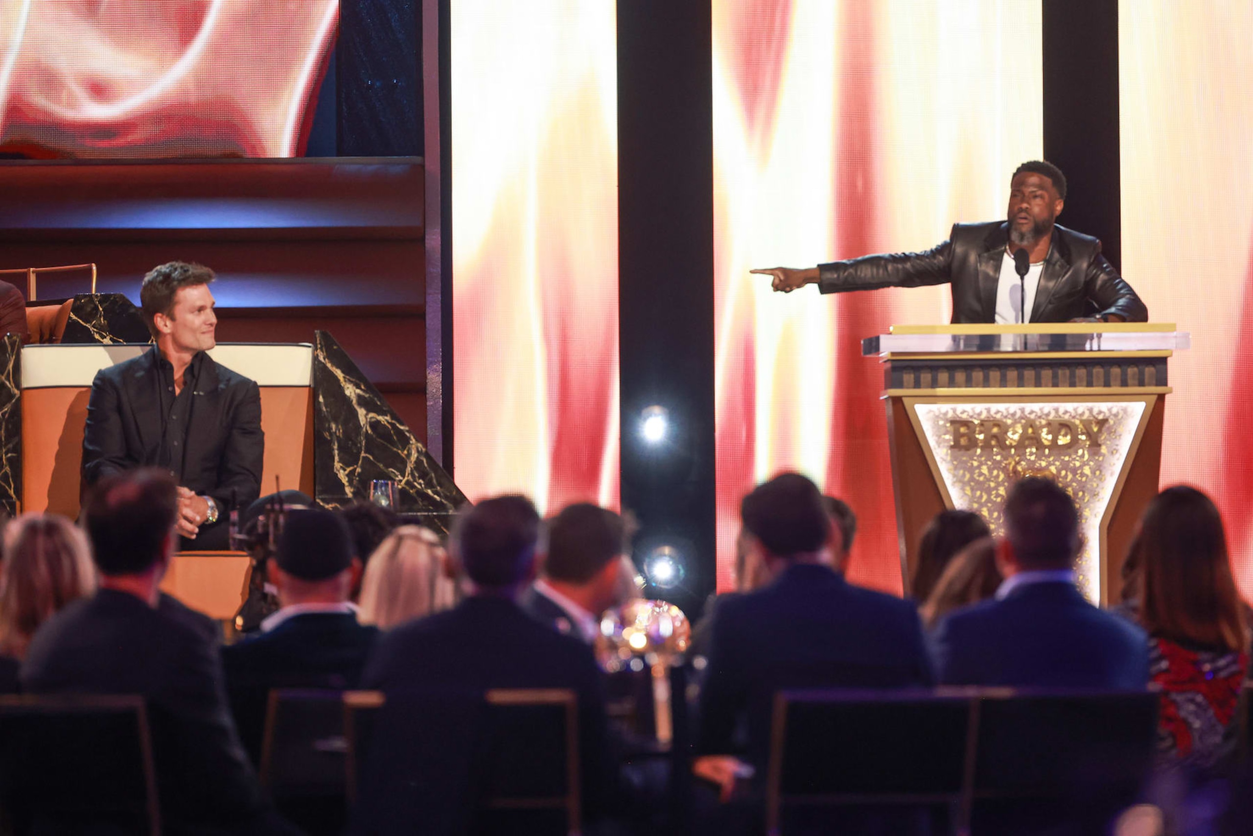 INGLEWOOD, CALIFORNIA - MAY 05: (L-R) Tom Brady and Kevin Hart speak onstage during G.R.O.A.T The Greatest Roast Of All Time: Tom Brady for the Netflix is a Joke Festival at The Kia Forum on May 05, 2024 in Inglewood, California.  (Photo by Matt Winkelmeyer/Getty Images for Netflix)