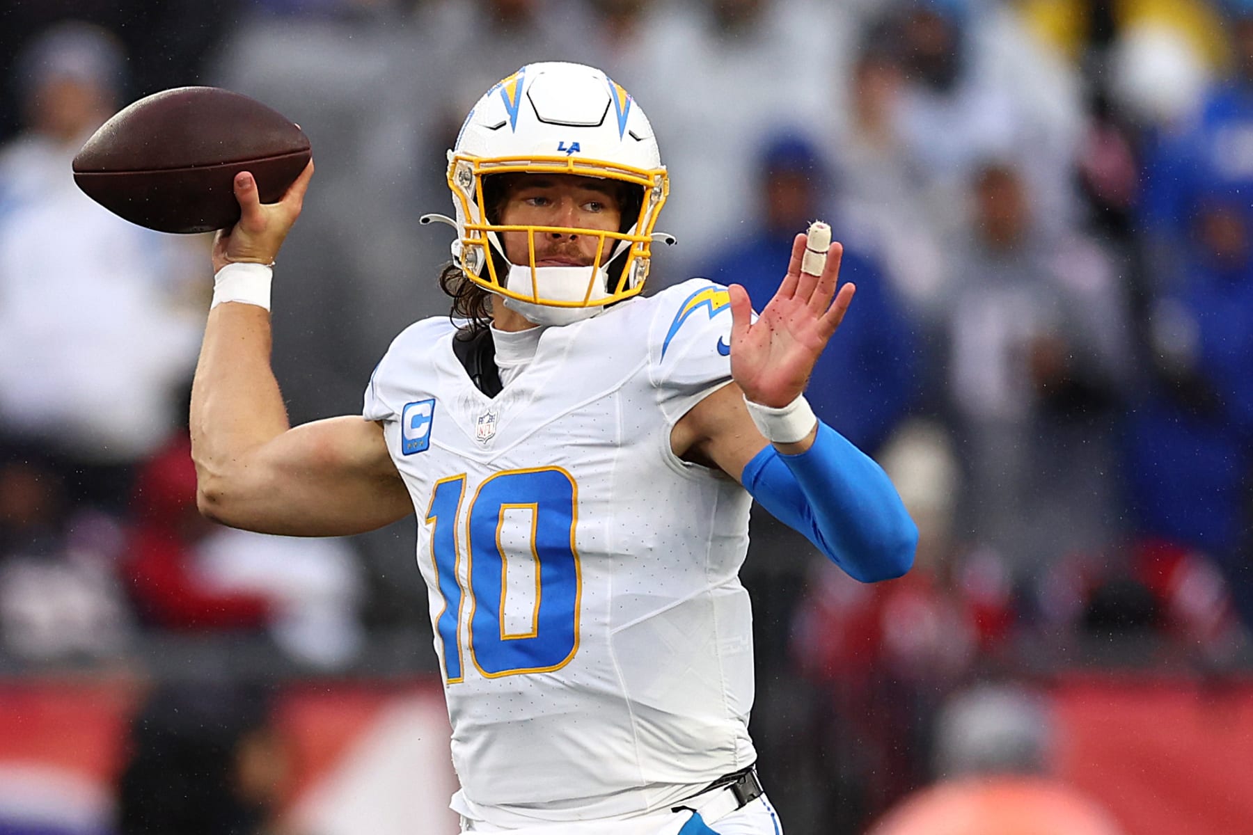 FOXBOROUGH, MASSACHUSETTS - DECEMBER 03: Justin Herbert #10 of the Los Angeles Chargers makes a pass against the New England Patriots  at Gillette Stadium on December 03, 2023 in Foxborough, Massachusetts. (Photo by Maddie Meyer/Getty Images)