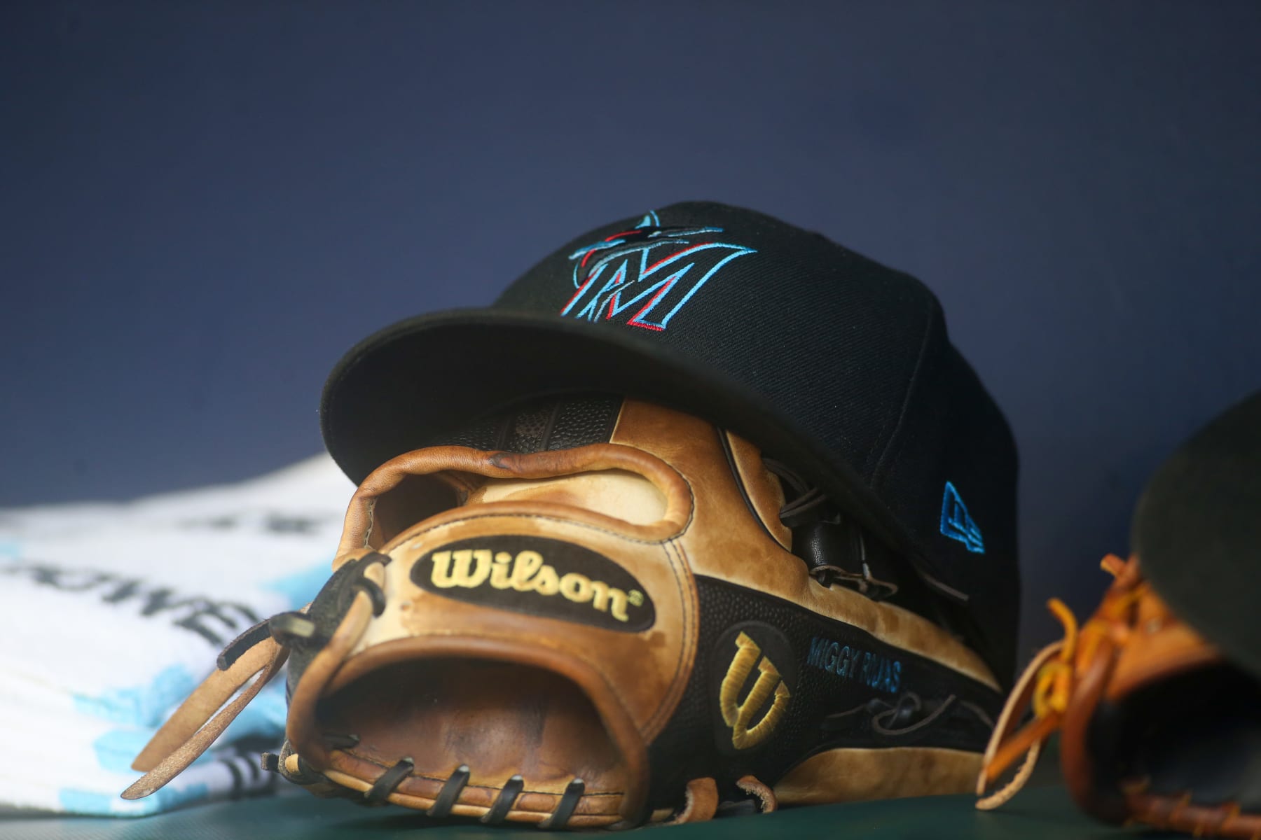 ATLANTA, GA - SEPTEMBER 04: A detailed view of a Miami Marlins hat and glove on the bench against the Atlanta Braves in the seventh inning at Truist Park on September 4, 2022 in Atlanta, Georgia. (Photo by Brett Davis/Getty Images) ATLANTA, GA - SEPTEMBER 04: A detailed view of a Miami Marlins hat and glove on the bench against the Atlanta Braves in the seventh inning at Truist Park on September 4, 2022 in Atlanta, Georgia. (Photo by Brett Davis/Getty Images)