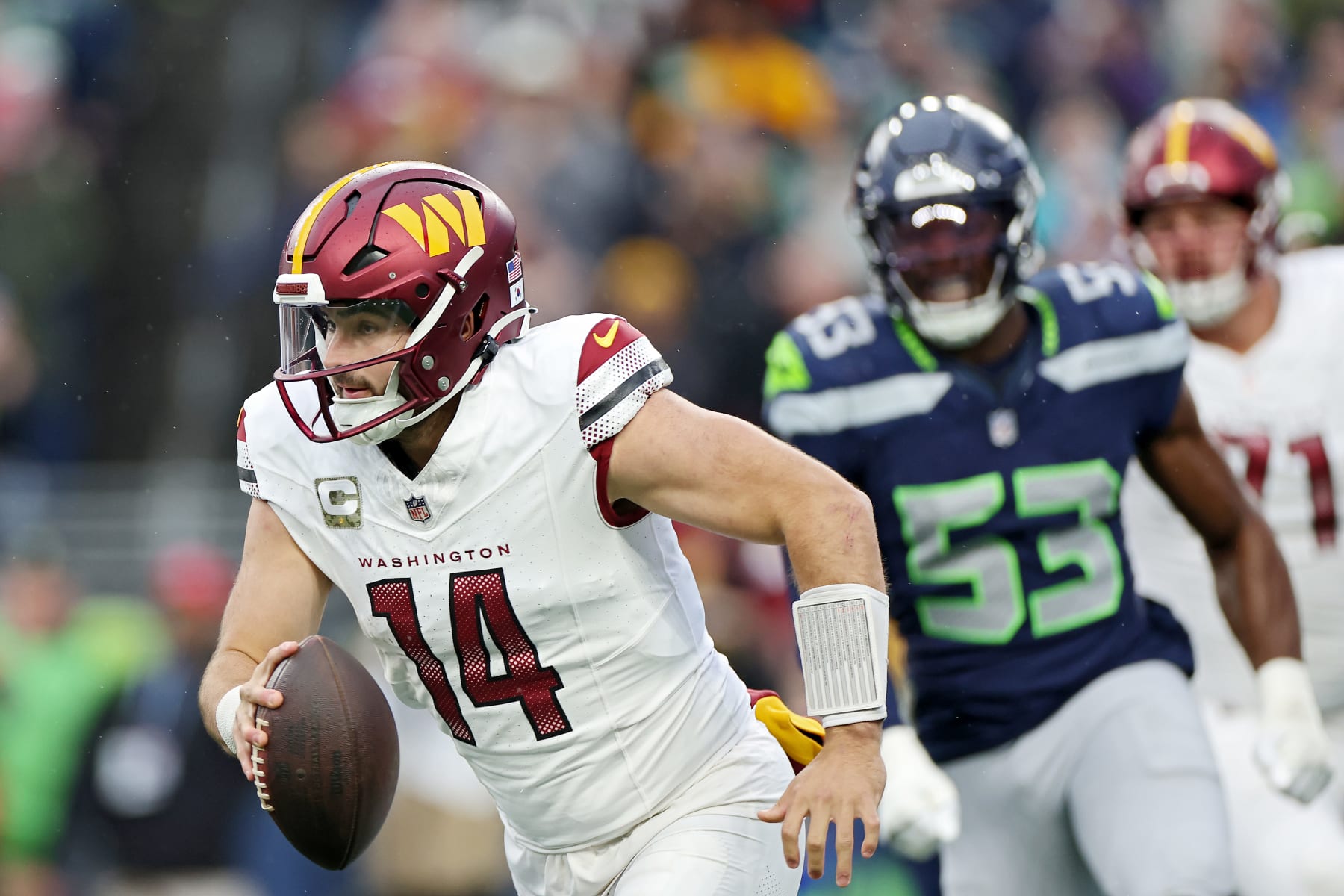 SEATTLE, WASHINGTON - NOVEMBER 12: Sam Howell #14 of the Washington Commanders scrambles for yards during the third quarter against the Seattle Seahawks at Lumen Field on November 12, 2023 in Seattle, Washington. (Photo by Steph Chambers/Getty Images)