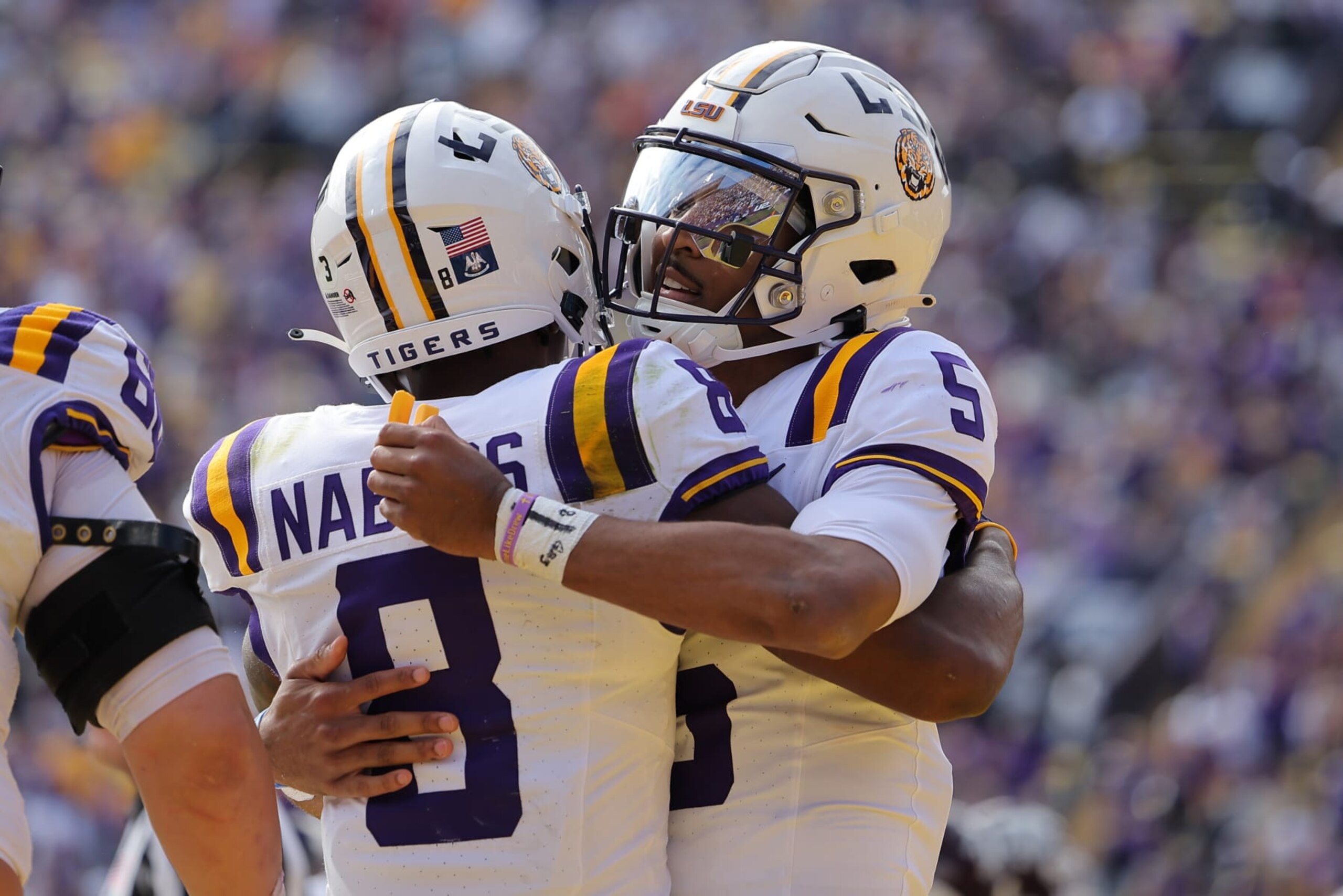 BATON ROUGE, LOUISIANA - NOVEMBER 25: Jayden Daniels #5 and Malik Nabers #8 of the LSU Tigers celebrates a touchdown during a game against the Texas A&M Aggies at Tiger Stadium on November 25, 2023 in Baton Rouge, Louisiana. (Photo by Jonathan Bachman/Getty Images)