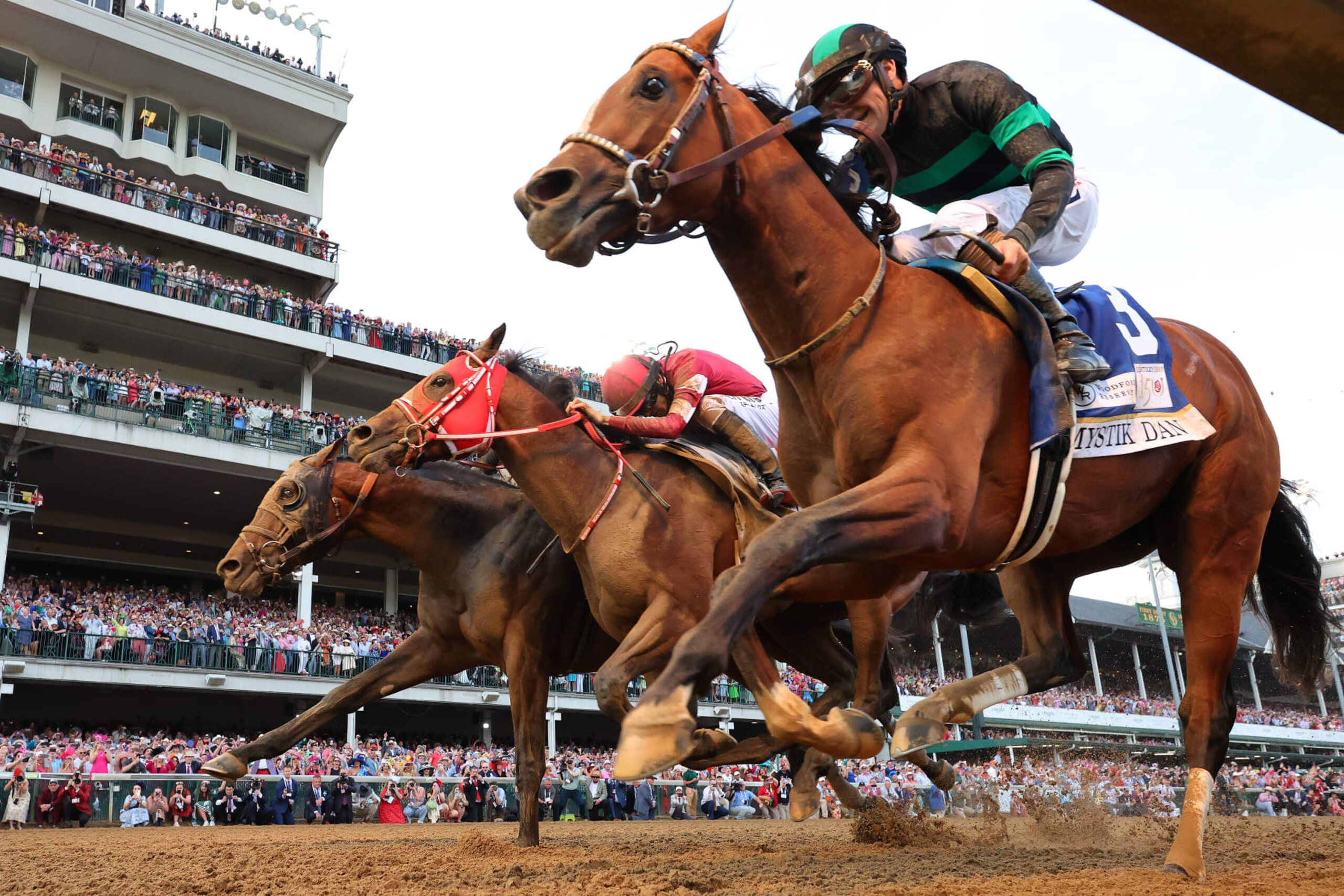 LOUISVILLE, KENTUCKY - MAY 04: Mystik Dan #3, ridden by jockey Brian J. Hernandez Jr. (R), crosses the finish line ahead of Sierra Leone #2, ridden by jockey Tyler Gaffalione and Forever Young, ridden by jockey Ryusei Sakai to win the 150th running of the Kentucky Derby at Churchill Downs on May 04, 2024 in Louisville, Kentucky. (Photo by Michael Reaves/Getty Images)