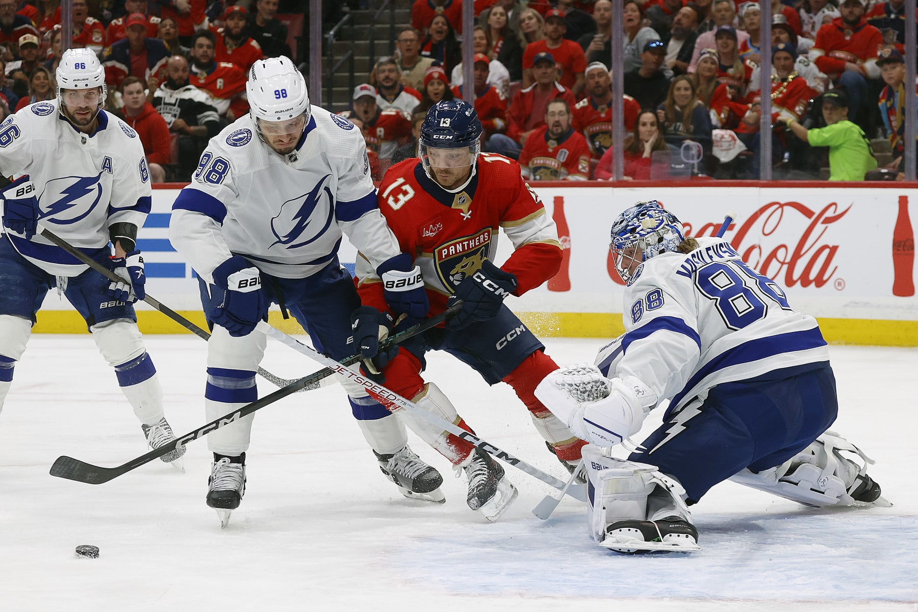 SUNRISE, FLORIDA - APRIL 29: Goaltender Andrei Vasilevskiy #88 of the Tampa Bay Lightning defends the net with the help of teammate Mikhail Sergachev #98 against Sam Reinhart #13 of the Florida Panthersin Game Five of the First Round of the 2024 Stanley Cup Playoffs at the Amerant Bank Arena on April 29, 2024 in Sunrise, Florida. (Photo by Eliot J. Schechter/NHLI via Getty Images)