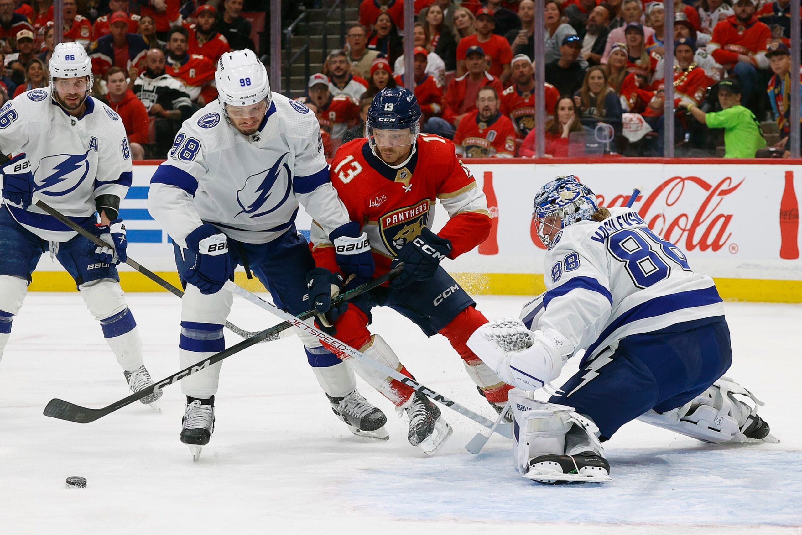 SUNRISE, FLORIDA - APRIL 29: Goaltender Andrei Vasilevskiy #88 of the Tampa Bay Lightning defends the net with the help of teammate Mikhail Sergachev #98 against Sam Reinhart #13 of the Florida Panthersin Game Five of the First Round of the 2024 Stanley Cup Playoffs at the Amerant Bank Arena on April 29, 2024 in Sunrise, Florida. (Photo by Eliot J. Schechter/NHLI via Getty Images)