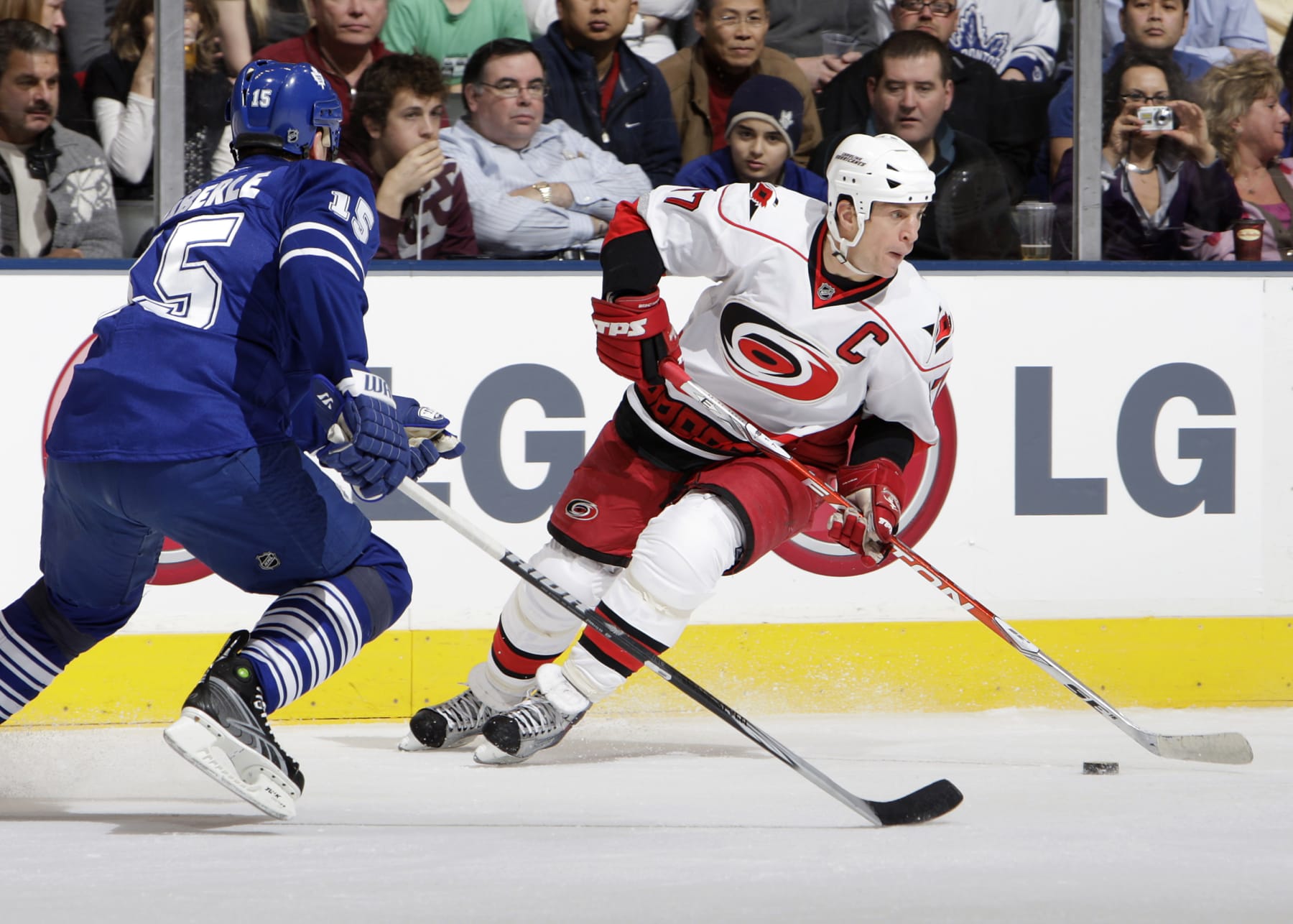 TORONTO - JANUARY 12:  Tomas Kaberle #15 of the Toronto Maple Leafs defends against Rod Brind'Amour #17 of the Carolina Hurricanes during game action January 12, 2010 at the Air Canada Centre in Toronto, Ontario, Canada. (Photo by Graig Abel/NHLI via Getty Images)