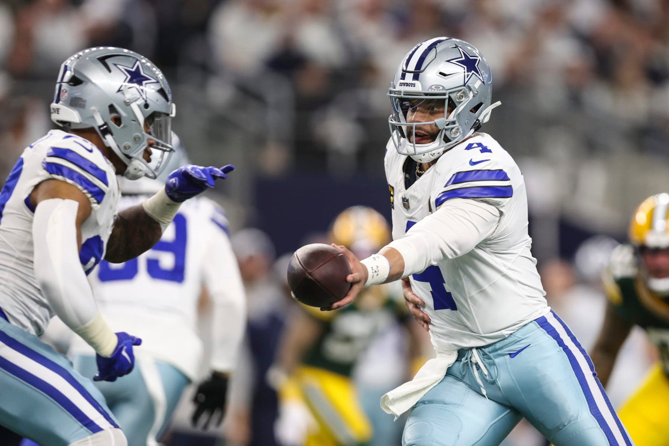 ARLINGTON, TX - JANUARY 14: Dak Prescott #4 of the Dallas Cowboys hands the ball off during an NFL wild-card playoff football game against the Green Bay Packers at AT&T Stadium on January 14, 2024 in Arlington, Texas. (Photo by Perry Knotts/Getty Images)