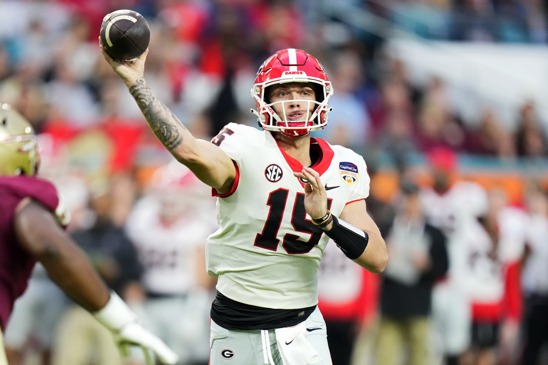 MIAMI GARDENS, FLORIDA - DECEMBER 30: Carson Beck #15 of the Georgia Bulldogs throws a pass in the second quarter against the Florida State Seminoles during the Capital One Orange Bowl at Hard Rock Stadium on December 30, 2023 in Miami Gardens, Florida. (Photo by Rich Storry/Getty Images)