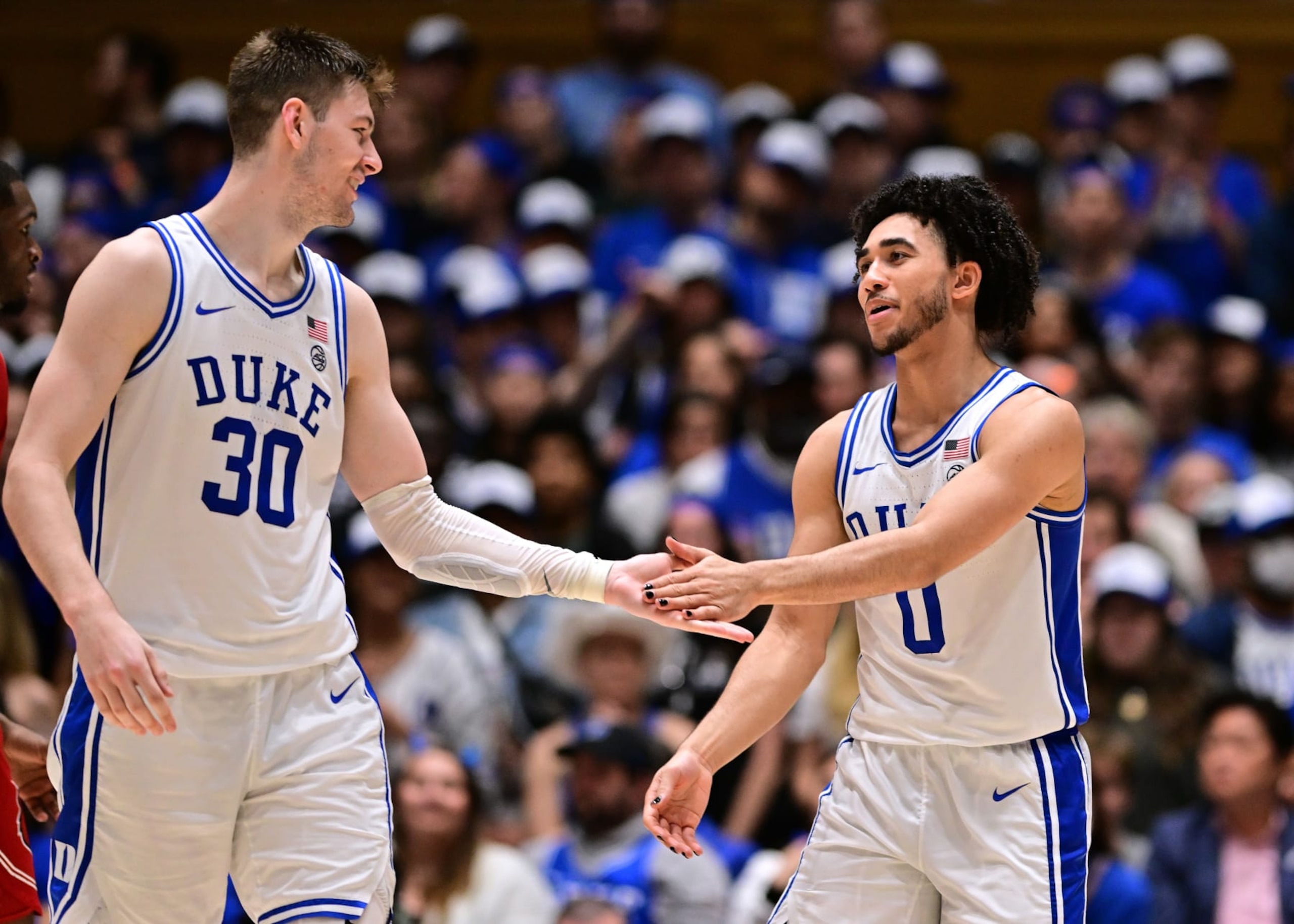 DURHAM, NORTH CAROLINA - FEBRUARY 28: Kyle Filipowski #30 high-fives Jared McCain #0 of the Duke Blue Devils during the game against the Louisville Cardinals at Cameron Indoor Stadium on February 28, 2024 in Durham, North Carolina. (Photo by Grant Halverson/Getty Images) DURHAM, NORTH CAROLINA - FEBRUARY 28: Kyle Filipowski #30 high-fives Jared McCain #0 of the Duke Blue Devils during the game against the Louisville Cardinals at Cameron Indoor Stadium on February 28, 2024 in Durham, North Carolina. (Photo by Grant Halverson/Getty Images)