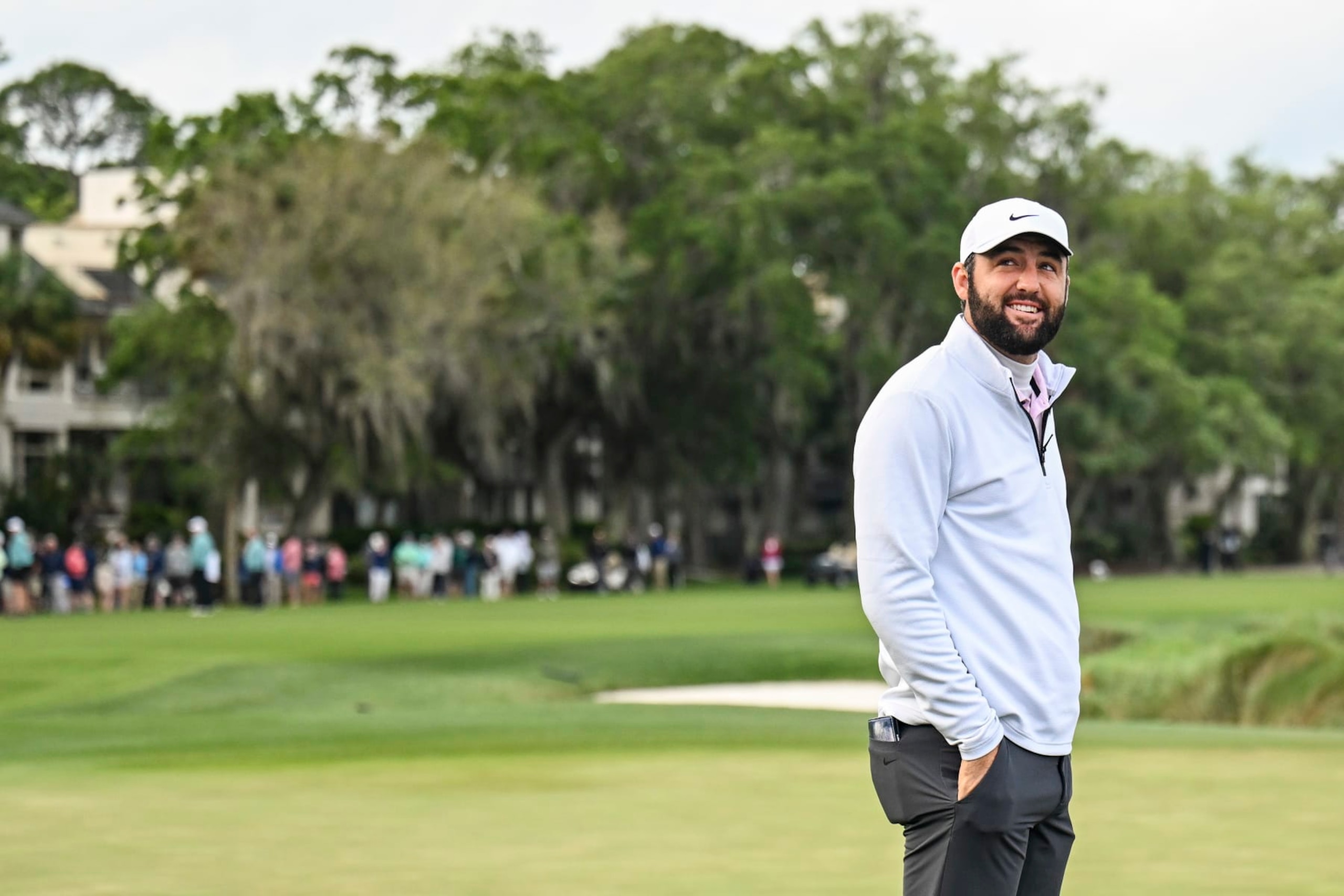 HILTON HEAD ISLAND, SOUTH CAROLINA - APRIL 22:  Scottie Scheffler smiles with caddie Ted Scott following his three stroke victory on the 18th hole green during the continuation of the final round of the RBC Heritage at Harbour Town Golf Links on April 22, 2024 in Hilton Head Island, South Carolina. (Photo by Keyur Khamar/PGA TOUR via Getty Images)