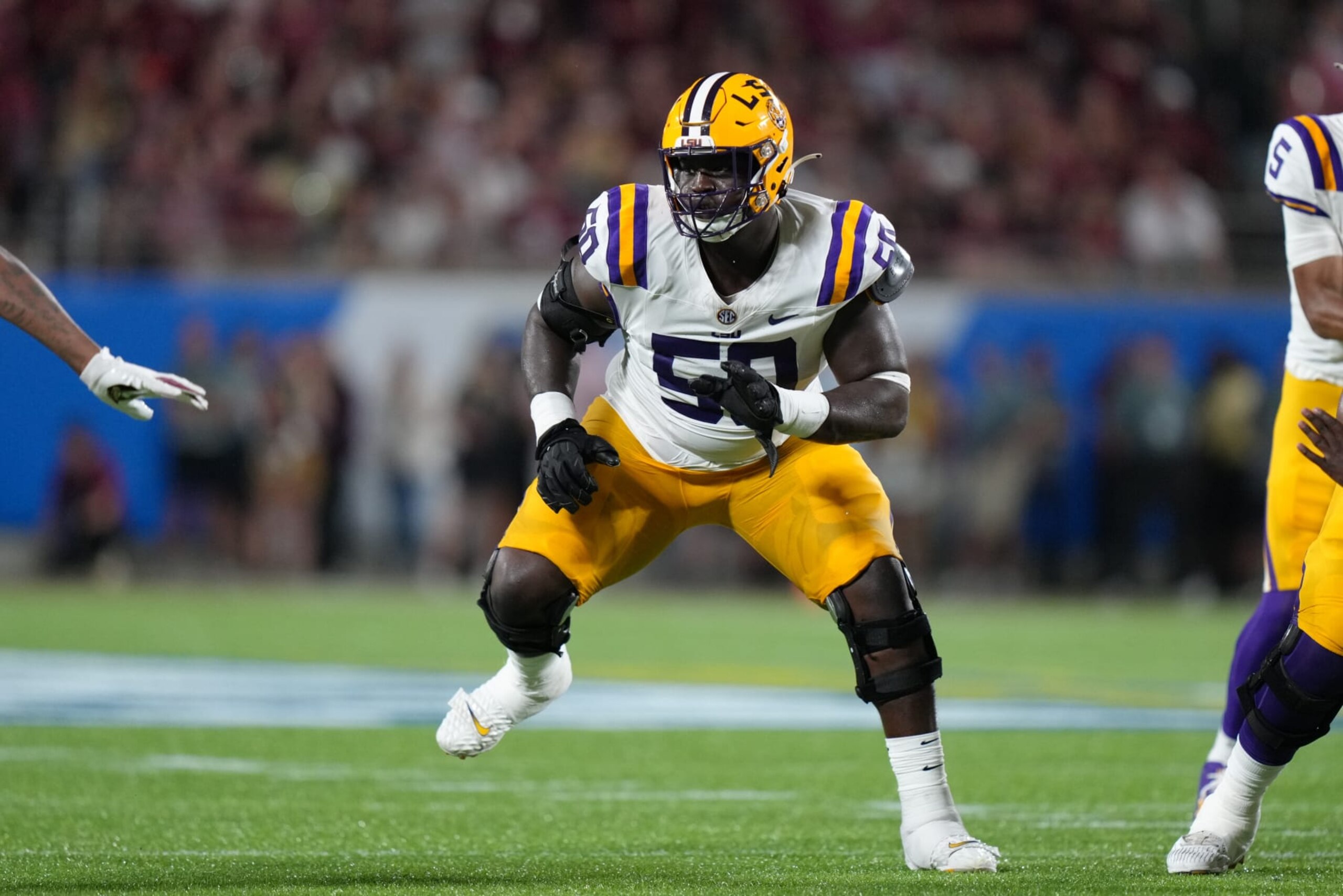 ORLANDO, FL - SEPTEMBER 03: LSU Tigers offensive lineman Emery Jones Jr. (50) looks to block an incoming defensive lineman during the Camping World Kickoff game between the LSU Tigers and the Florida State Seminoles, on Sunday, September 3, 2023 at Camping World Stadium in Orlando, Fla. (Photo by Peter Joneleit/Icon Sportswire via Getty Images) ORLANDO, FL - SEPTEMBER 03: LSU Tigers offensive lineman Emery Jones Jr. (50) looks to block an incoming defensive lineman during the Camping World Kickoff game between the LSU Tigers and the Florida State Seminoles, on Sunday, September 3, 2023 at Camping World Stadium in Orlando, Fla. (Photo by Peter Joneleit/Icon Sportswire via Getty Images)