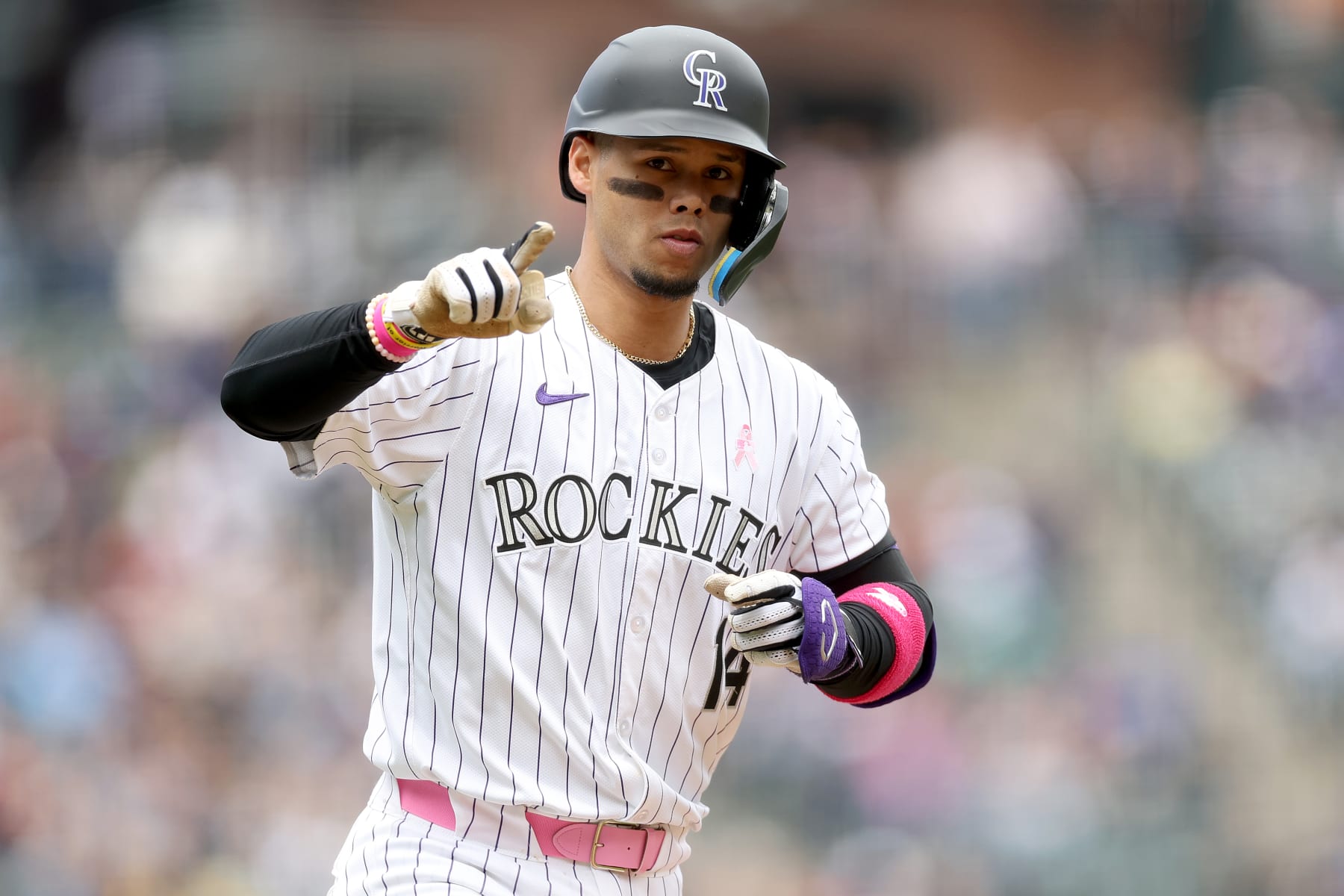 DENVER, COLORADO - MAY 12: Ezequiel Tovar #14 of the Colorado Rockies gestures as he circles the bases after hitting a 2 RBI home run against the Texas Rangers in the first inning at Coors Field on May 12, 2024 in Denver, Colorado. (Photo by Matthew Stockman/Getty Images)