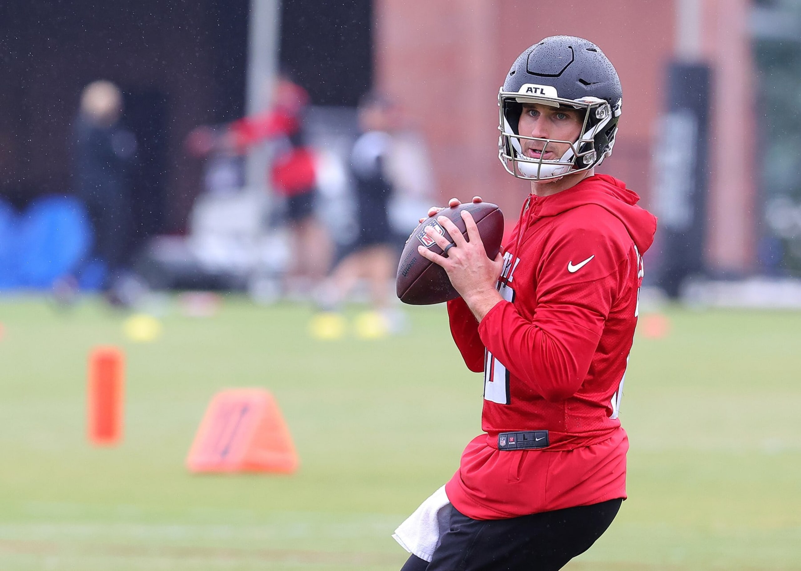 FLOWERY BRANCH, GEORGIA - MAY 14:  Quarterback Kirk Cousins #18 of the Atlanta Falcons looks to pass during OTA offseason workouts at the Atlanta Falcons training facility on May 14, 2024 in Flowery Branch, Georgia. (Photo by Kevin C. Cox/Getty Images)