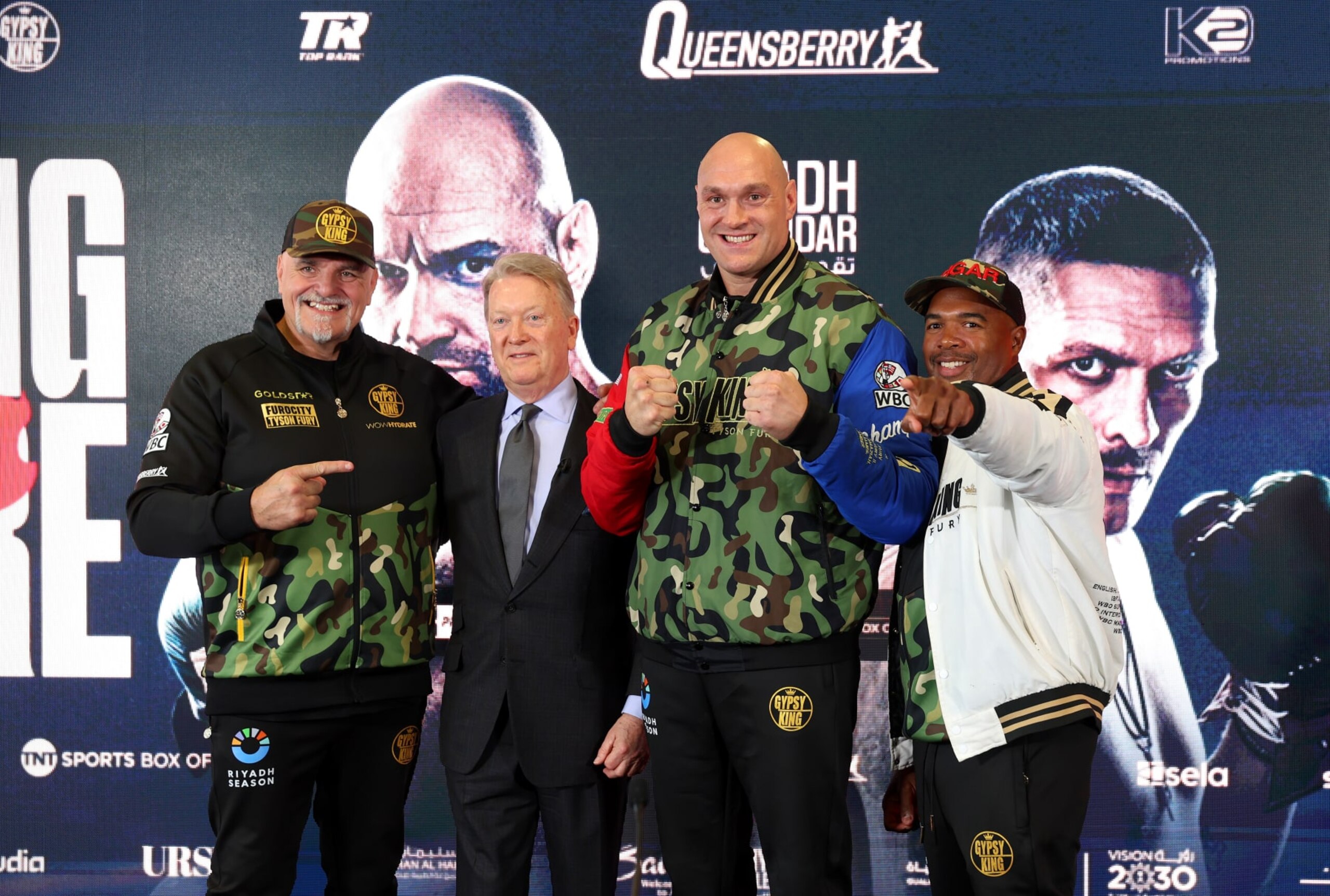 MORECAMBE, ENGLAND - APRIL 10: Father of Tyson Fury, John Fury, Boxing Promoter, Frank Warren, Tyson Fury, and Boxing Trainer, SugarHill Steward, pose for a photo after a press conference ahead of the IBF, IBO, WBA, WBO and WBC Undisputed World Heavyweight title fight against Oleksandr Usyk on the 'Ring of Fire' card in Riyadh, Saudi Arabia at Mazuma Stadium on April 10, 2024 in Morecambe, England.  (Photo by Nathan Stirk/Getty Images)