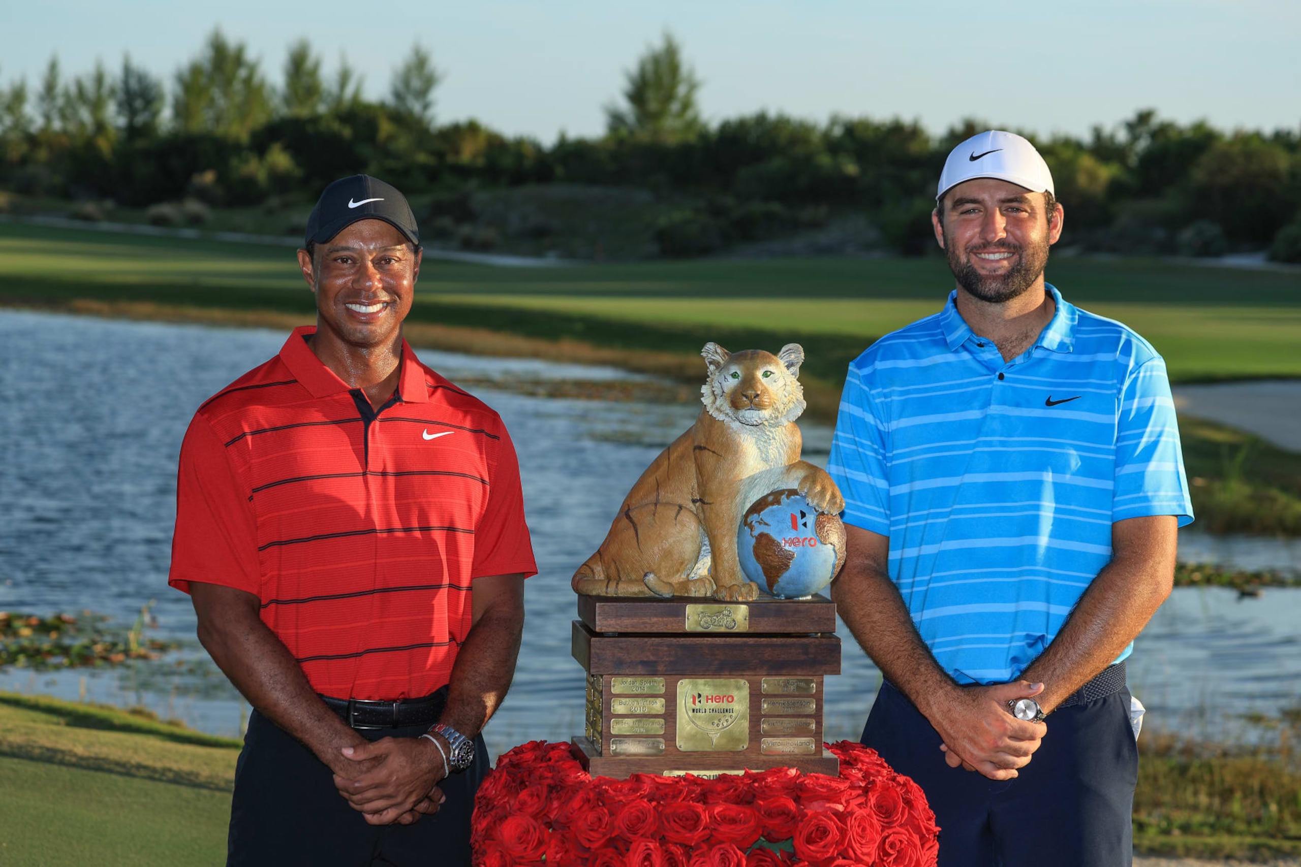 NASSAU, BAHAMAS - DECEMBER 03: Scottie Scheffler of The United States is presented with the Hero World Challenge Trophy by tournament host Tiger Woods of The United States after his win in the final round of the Hero World Challenge at Albany Golf Course on December 03, 2023 in Nassau, . (Photo by David Cannon/Getty Images)