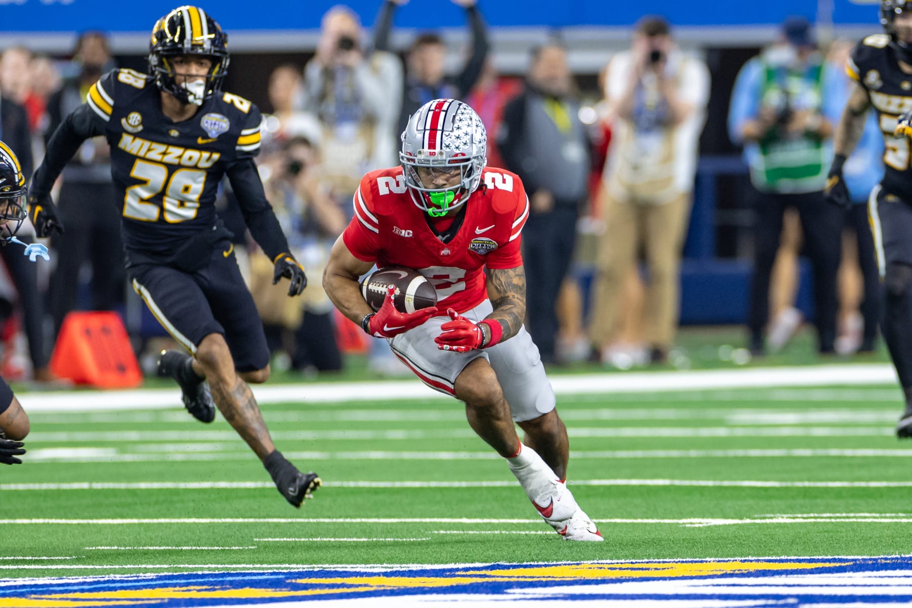 ARLINGTON, TX - DECEMBER 29: Ohio State Buckeyes wide receiver Emeka Egbuka (#2) runs up field after a catch during the Goodyear Cotton Bowl Classic football game between the Ohio State Buckeyes and Missouri Tigers on December 29, 2023 at AT&T Stadium in Arlington, TX.  (Photo by Matthew Visinsky/Icon Sportswire via Getty Images)