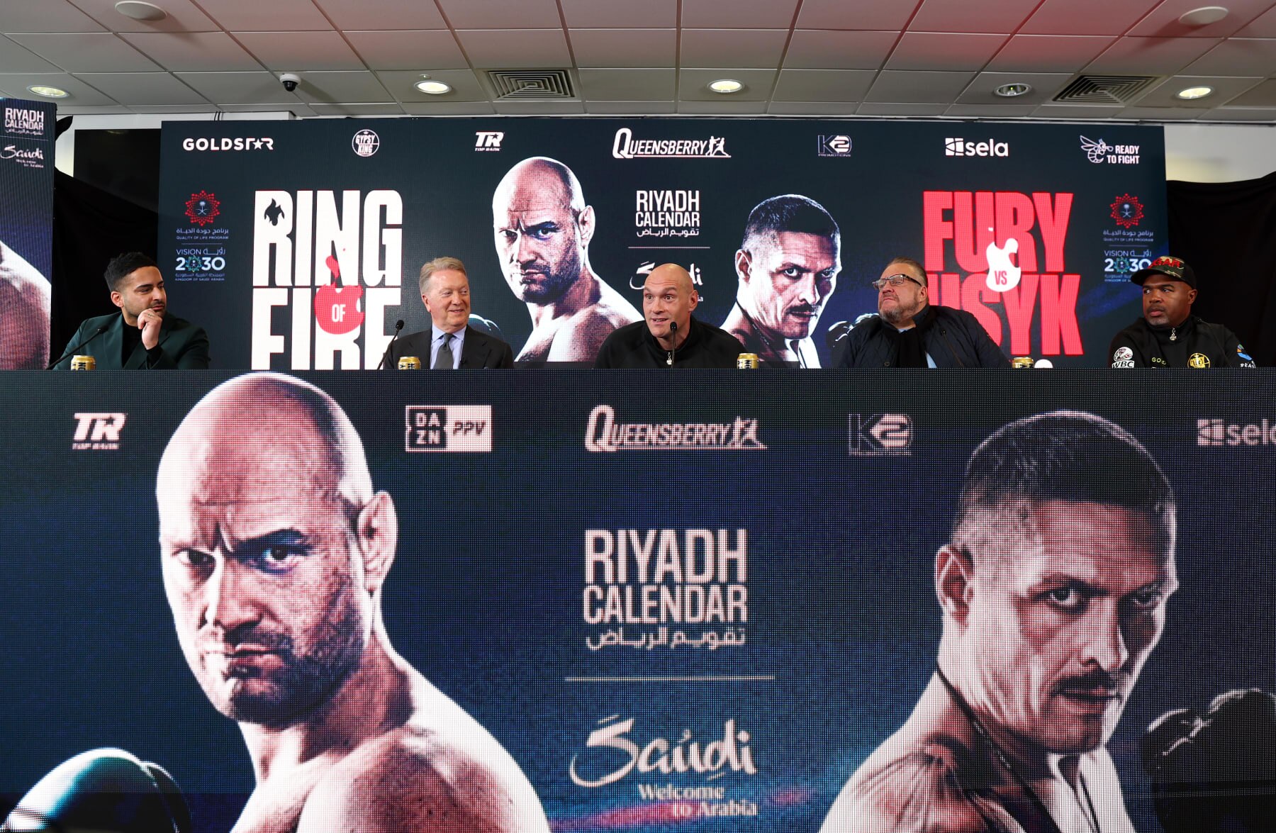 MORECAMBE, ENGLAND - APRIL 10: Boxing Promoter, Frank Warren, Tyson Fury, Spencer Brown, Manager of Tyson Fury and Founder of Gold Star Promotions and Boxing Trainer, SugarHill Steward, speak during a press conference ahead of the IBF, IBO, WBA, WBO and WBC Undisputed World Heavyweight title fight against Oleksandr Usyk on the 'Ring of Fire' card in Riyadh, Saudi Arabia at Mazuma Stadium on April 10, 2024 in Morecambe, England.  (Photo by Nathan Stirk/Getty Images)
