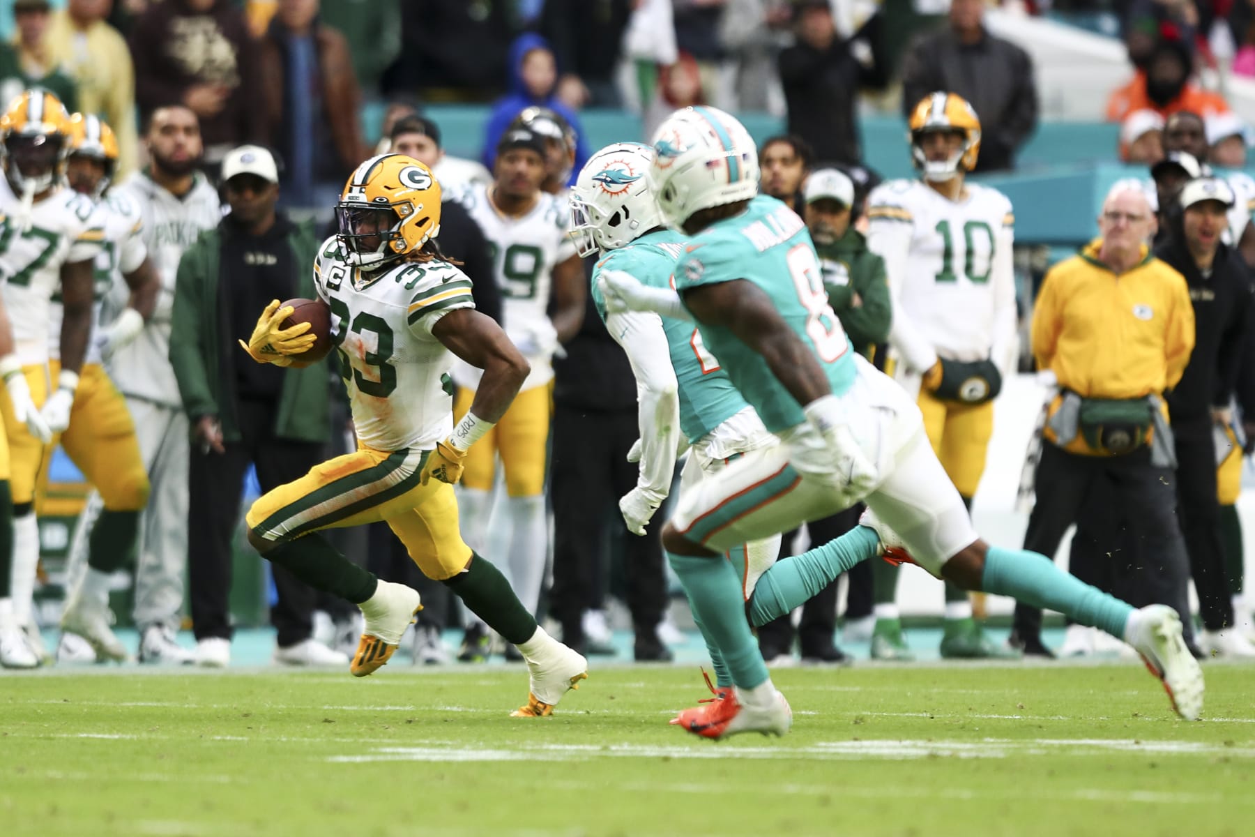 MIAMI GARDENS, FL - DECEMBER 25: Aaron Jones #33 of the Green Bay Packers carries the ball during an NFL football game against the Miami Dolphins, Sunday at Hard Rock Stadium on December 25, 2023 in Miami Gardens, Florida. (Photo by Kevin Sabitus/Getty Images)