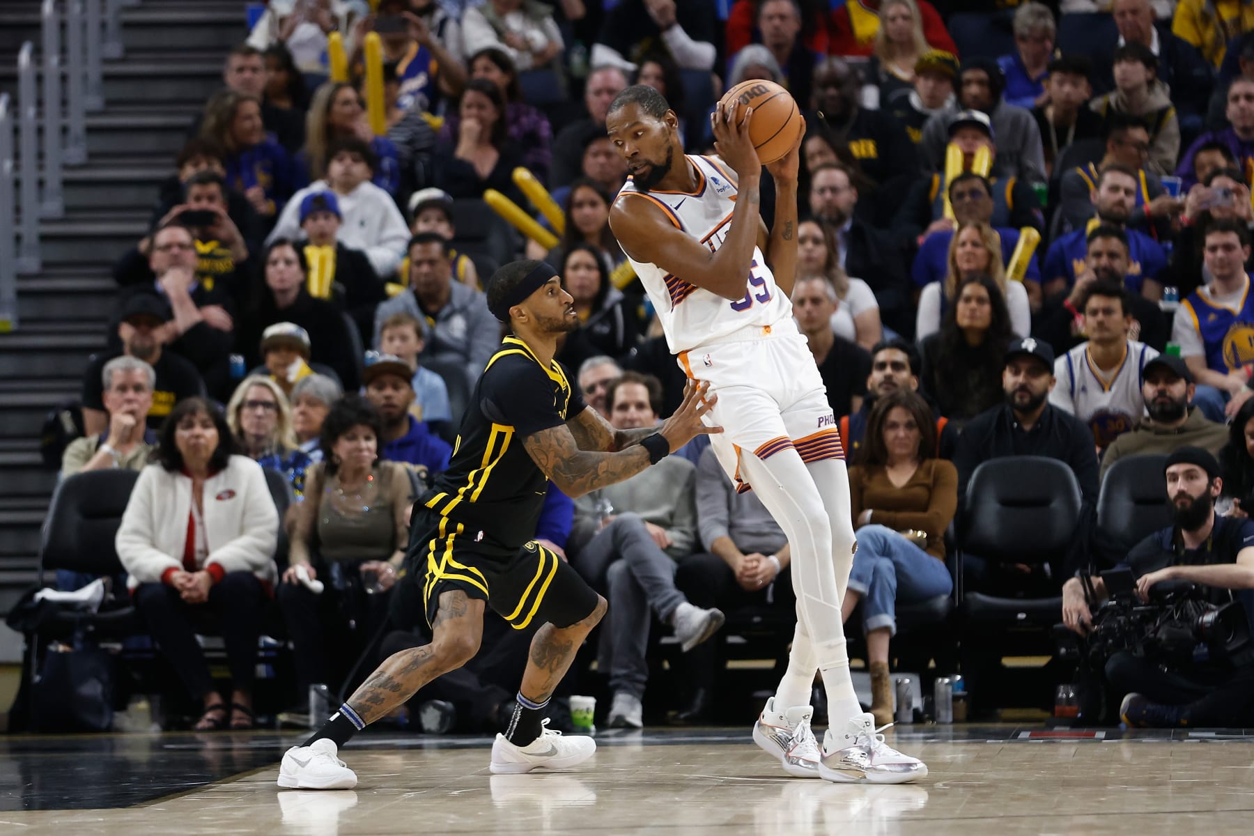 SAN FRANCISCO, CALIFORNIA - FEBRUARY 10: Kevin Durant #35 of the Phoenix Suns is defended by Gary Payton II #0 of the Golden State Warriors in the third quarter at Chase Center on February 10, 2024 in San Francisco, California. NOTE TO USER: User expressly acknowledges and agrees that, by downloading and or using this photograph, User is consenting to the terms and conditions of the Getty Images License Agreement. (Photo by Lachlan Cunningham/Getty Images)