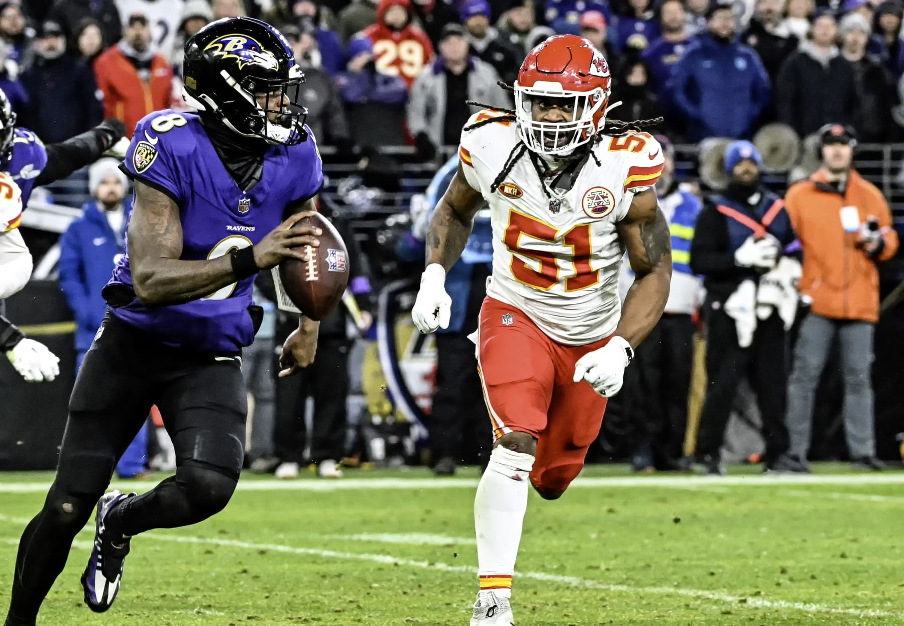 Lamar Jackson runs from Chiefs defensive end Mike Danna