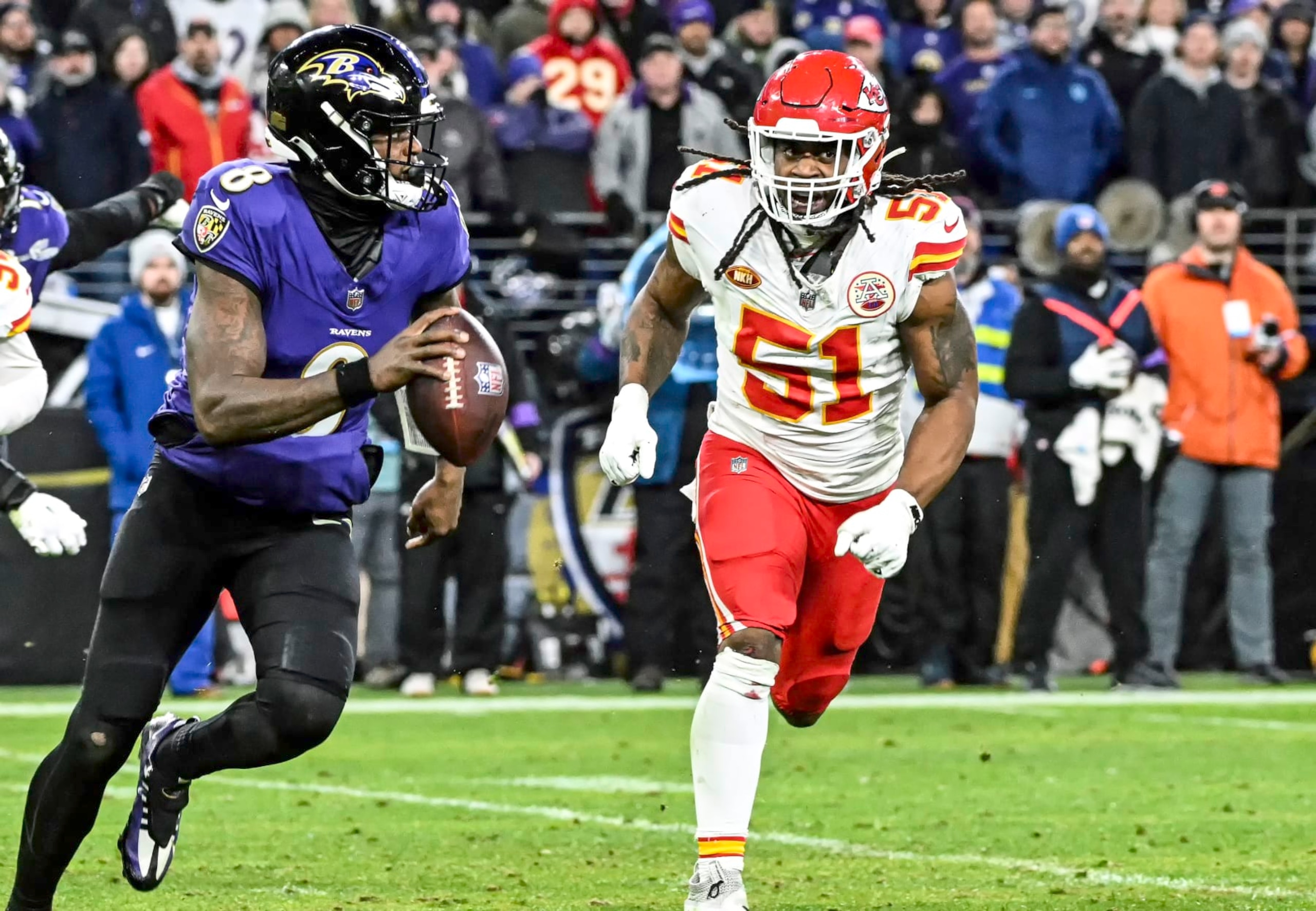 Lamar Jackson runs from Chiefs defensive end Mike Danna