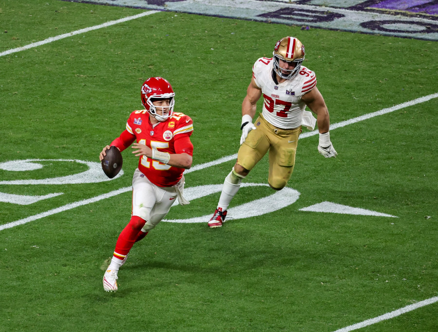 LAS VEGAS, NEVADA - FEBRUARY 11: Quarterback Patrick Mahomes #15 of the Kansas City Chiefs looks to throw under pressure from defensive end Nick Bosa #97 of the San Francisco 49ers in the fourth quarter of Super Bowl LVIII at Allegiant Stadium on February 11, 2024 in Las Vegas, Nevada. The Chiefs defeated the 49ers 25-22 in overtime. (Photo by Ethan Miller/Getty Images)