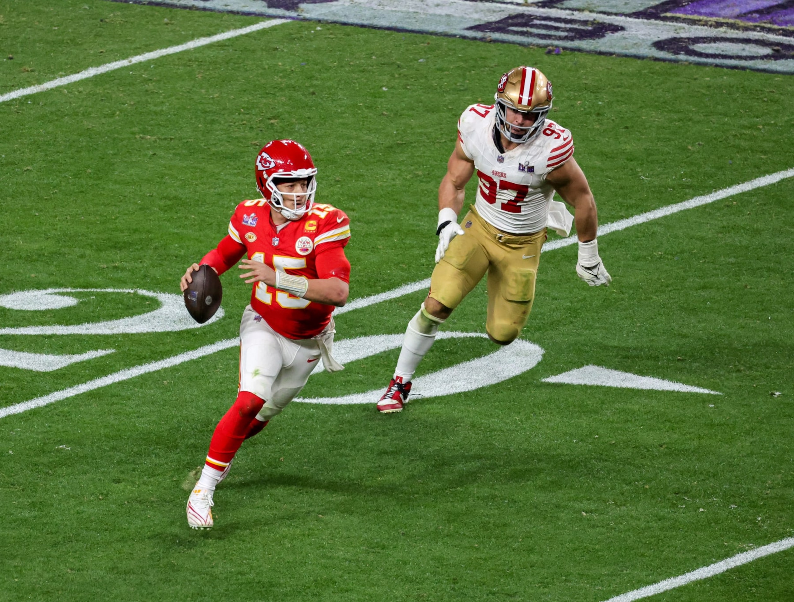 LAS VEGAS, NEVADA - FEBRUARY 11: Quarterback Patrick Mahomes #15 of the Kansas City Chiefs looks to throw under pressure from defensive end Nick Bosa #97 of the San Francisco 49ers in the fourth quarter of Super Bowl LVIII at Allegiant Stadium on February 11, 2024 in Las Vegas, Nevada. The Chiefs defeated the 49ers 25-22 in overtime. (Photo by Ethan Miller/Getty Images)