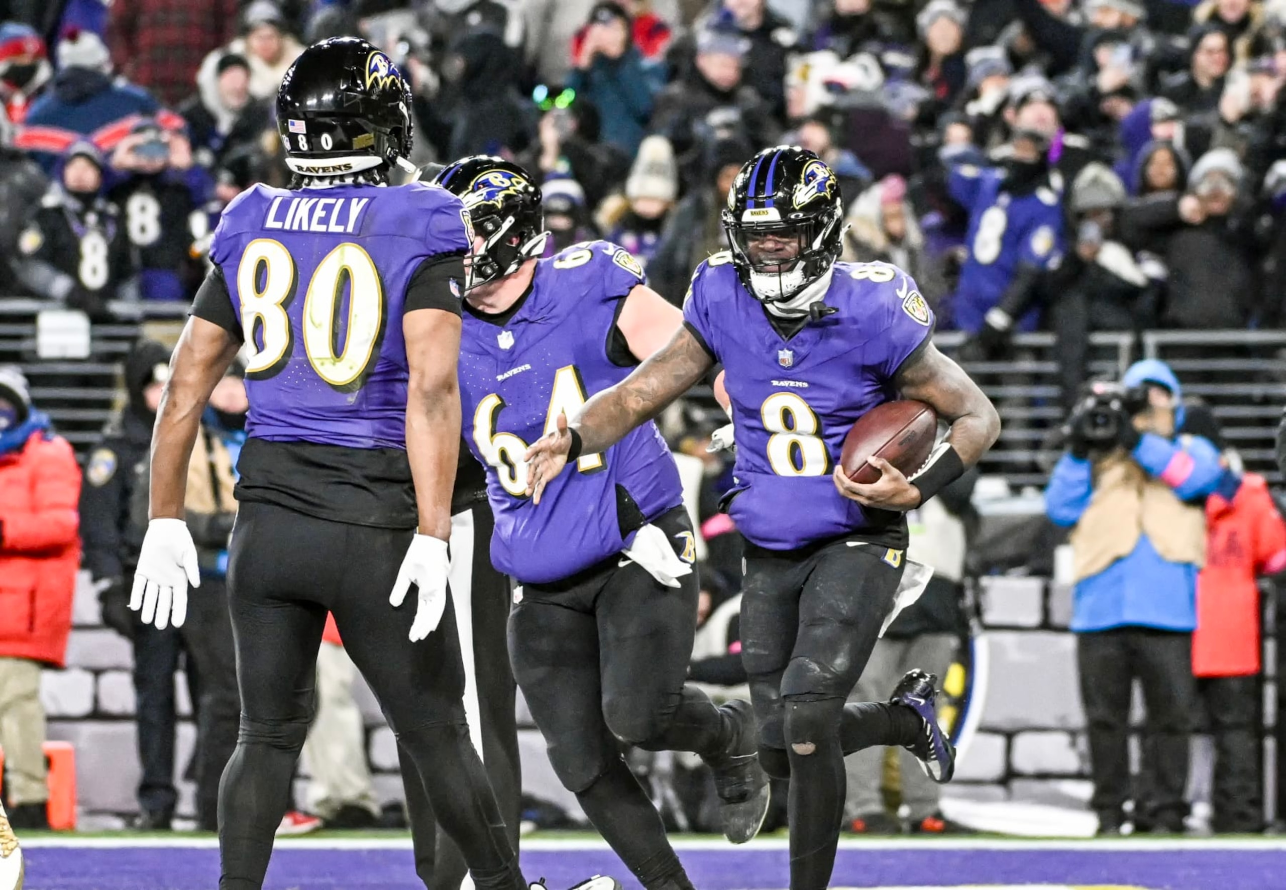 BALTIMORE, MD - JANUARY 20:  Baltimore Ravens quarterback Lamar Jackson (8) celebrates his touchdown  run with tight end Isaiah Likely (80) and center Tyler Linderbaum (64) during the Houston Texans game versus the Baltimore Ravens in the AFC Divisional Playoffs on January 20, 2024 at M&T Bank Stadium in Baltimore, MD.  (Photo by Mark Goldman/Icon Sportswire via Getty Images)