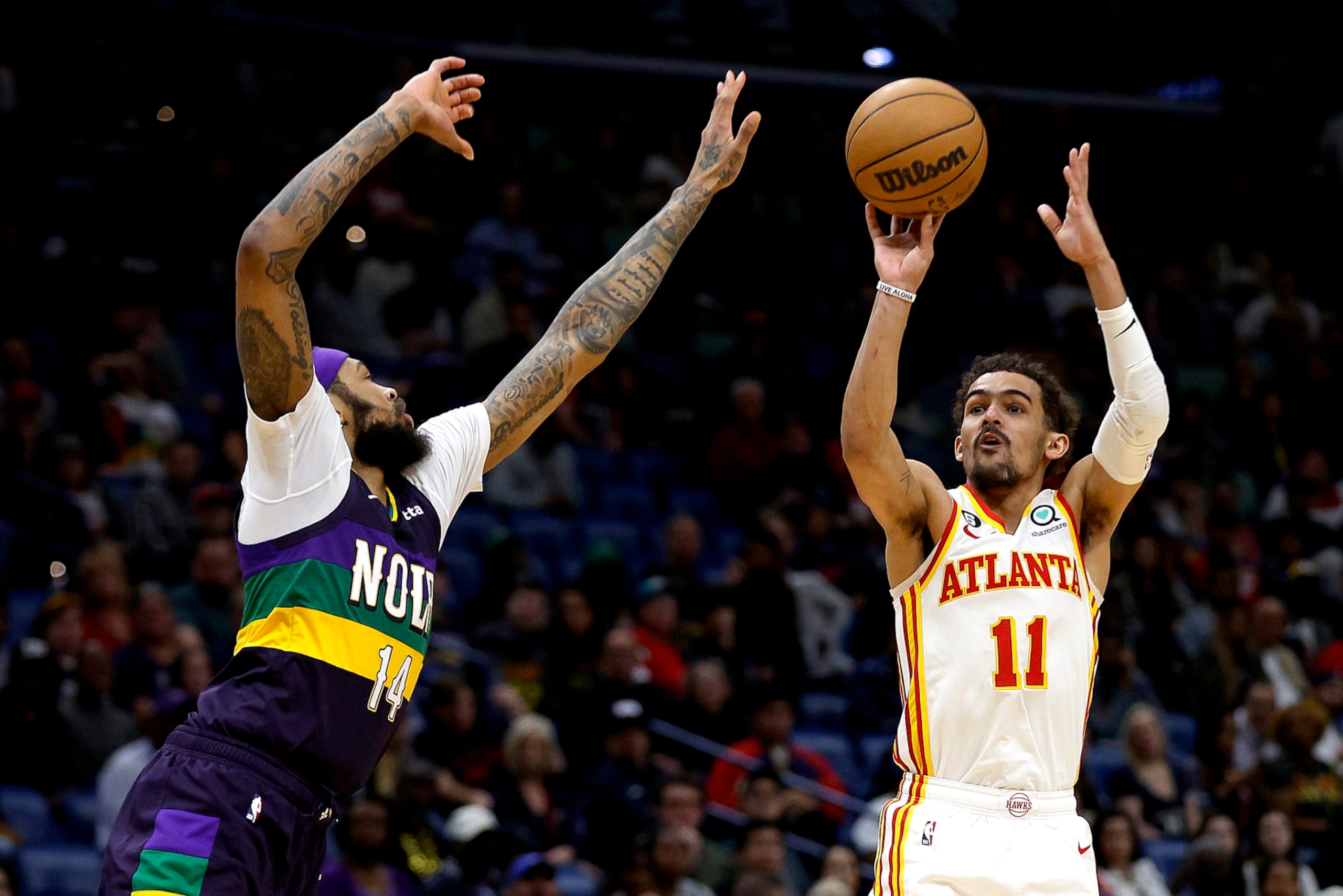 NEW ORLEANS, LOUISIANA - FEBRUARY 07: Trae Young #11 of the Atlanta Hawks shoots over Brandon Ingram #14 of the New Orleans Pelicans during the fourth quarter of an NBA game at Smoothie King Center on February 07, 2023 in New Orleans, Louisiana. NOTE TO USER: User expressly acknowledges and agrees that, by downloading and or using this photograph, User is consenting to the terms and conditions of the Getty Images License Agreement. (Photo by Sean Gardner/Getty Images)