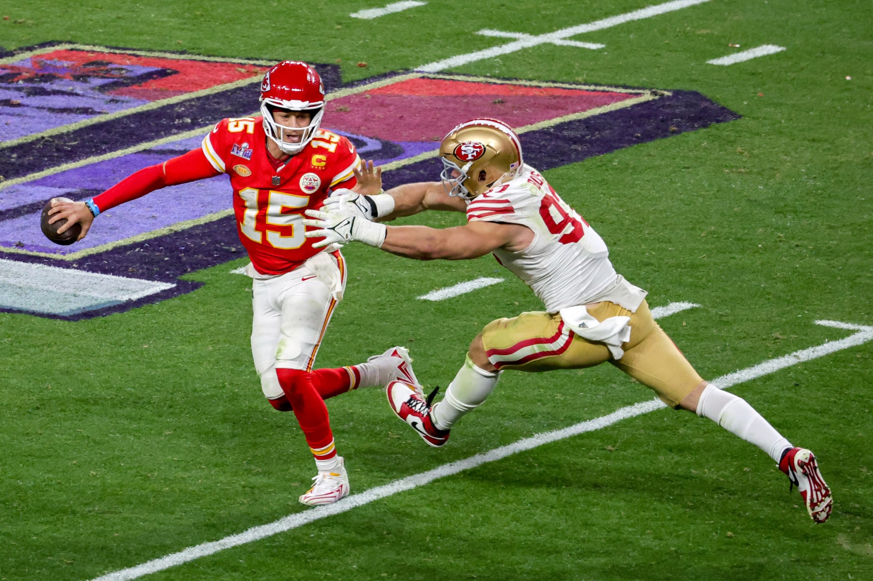 Patrick Mahomes looks to throw under pressure from Nick Bosa.