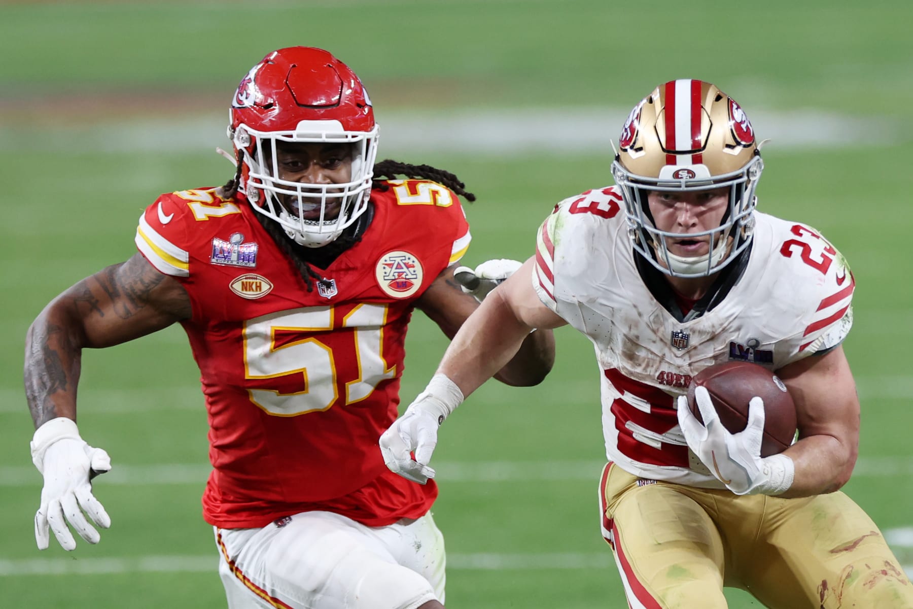 49ers running back Christian McCaffrey runs from Chiefs defensive end Mike Danna