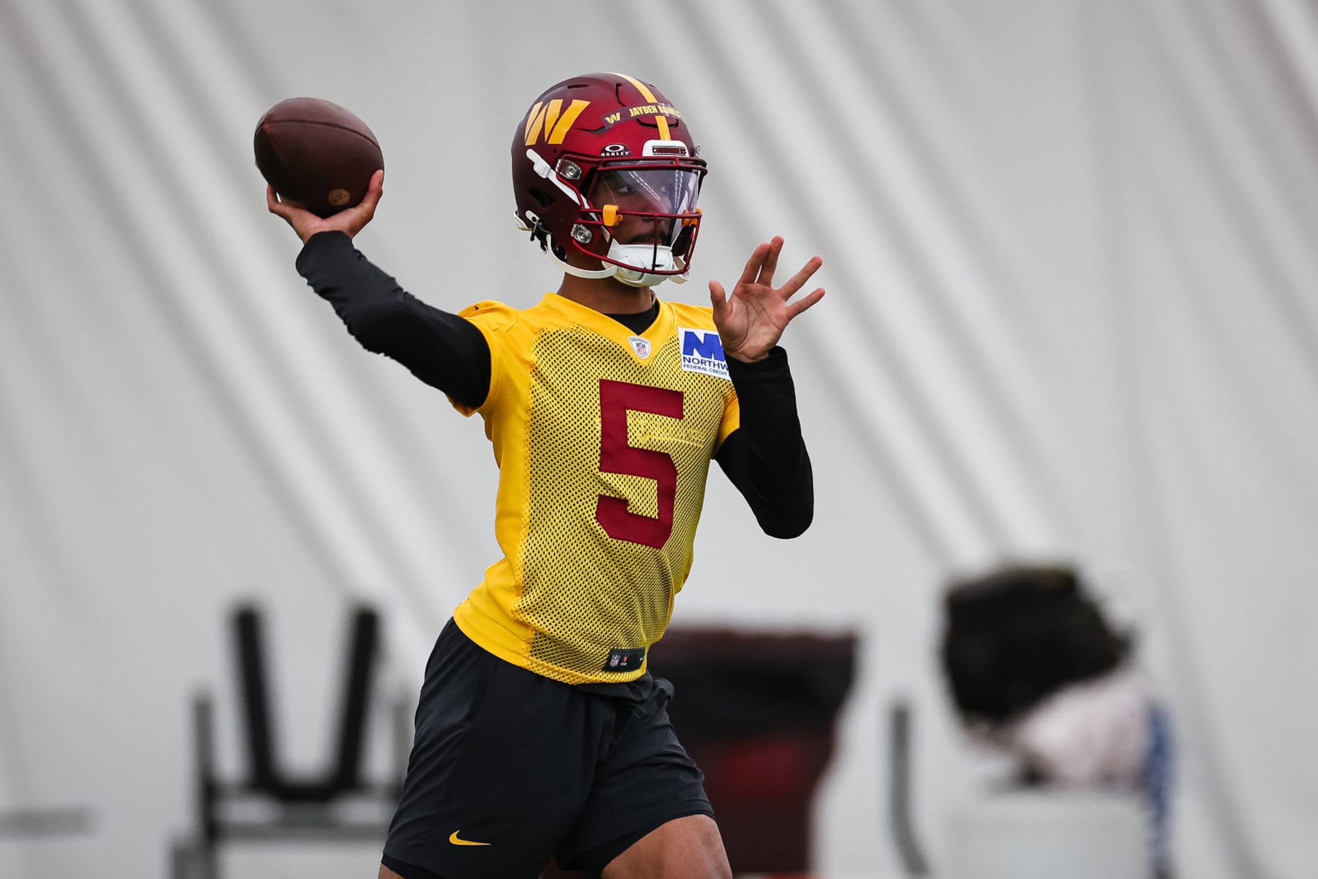 ASHBURN, VA - MAY 10: Jayden Daniels #5 of the Washington Commanders attempts a pass during Washington Commanders Rookie Minicamp at OrthoVirginia Training Center on May 10, 2024 in Ashburn, Virginia. (Photo by Scott Taetsch/Getty Images)