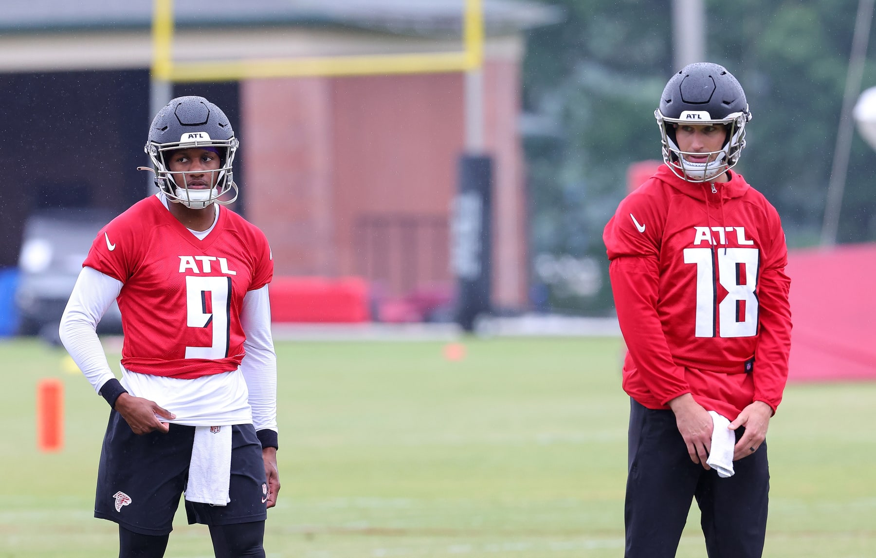 FLOWERY BRANCH, GEORGIA - MAY 14:  Quarterbacks Kirk Cousins #18 and Michael Penix Jr. #9 of the Atlanta Falcons look on during OTA offseason workouts at the Atlanta Falcons training facility on May 14, 2024 in Flowery Branch, Georgia. (Photo by Kevin C. Cox/Getty Images)