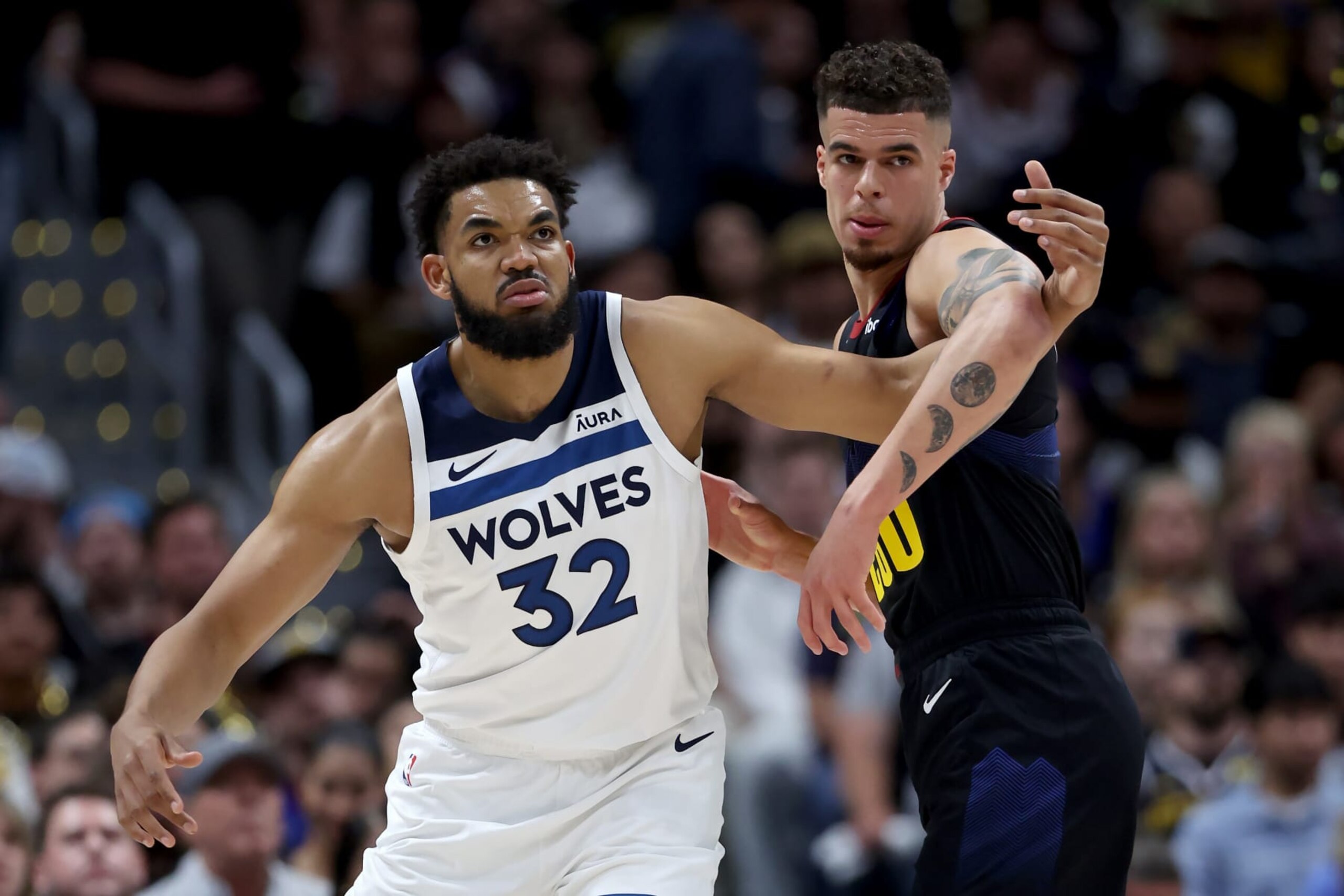 DENVER, COLORADO - MAY 14: Karl-Anthony Towns #32 of the Minnesota Timberwolves battles against Michael Porter Jr. #1 of the Denver Nuggets during the first quarter in Game Five of the Western Conference Second Round Playoffs at Ball Arena on May 14, 2024 in Denver, Colorado. NOTE TO USER: User expressly acknowledges and agrees that, by downloading and or using this photograph, User is consenting to the terms and conditions of the Getty Images License Agreement. (Photo by Matthew Stockman/Getty Images)