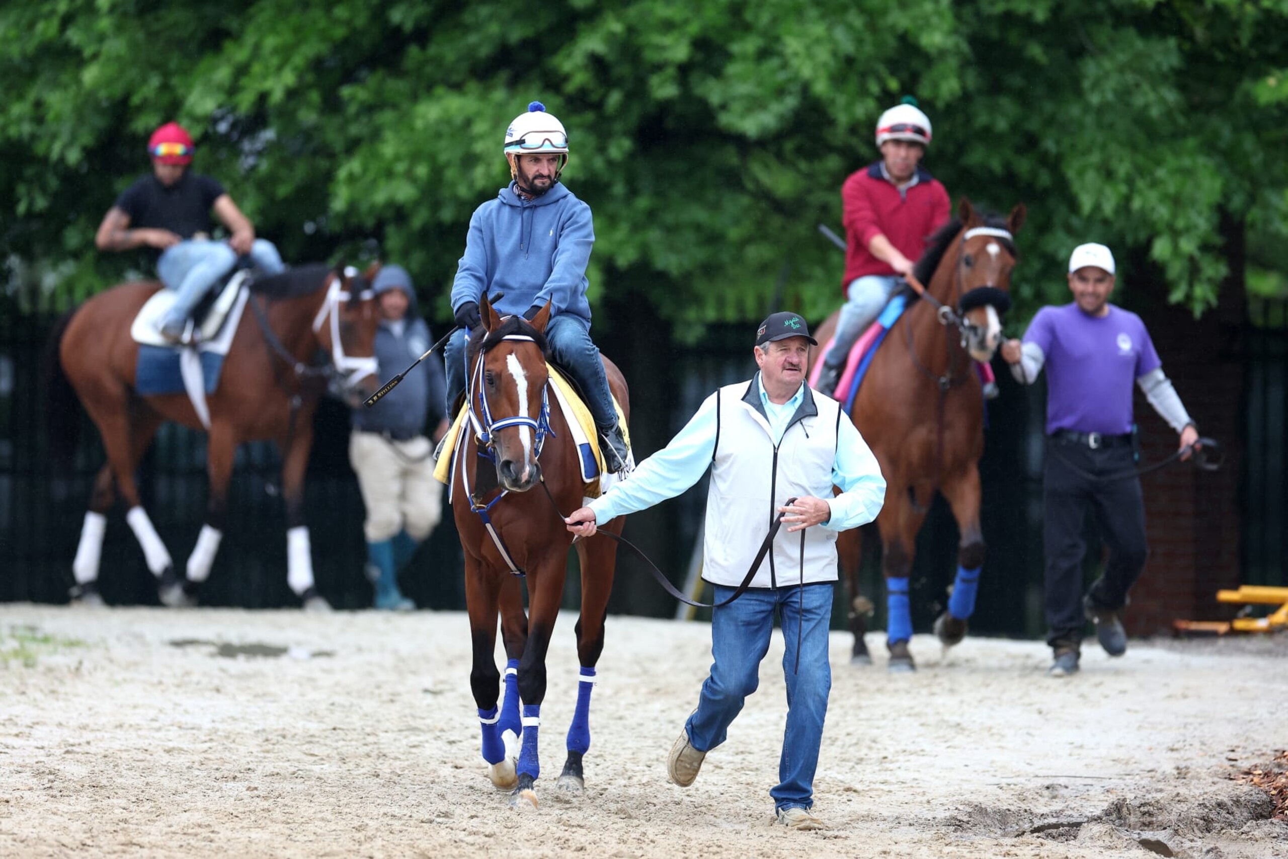 BALTIMORE, MARYLAND - MAY 15: Assistant trainer Ray Bryner leads Kentucky Derby winner Mystik Dan to the track during a training session ahead of the 149th running of the Preakness Stakes at Pimlico Race Course on May 15, 2024 in Baltimore, Maryland. (Photo by Rob Carr/Getty Images)