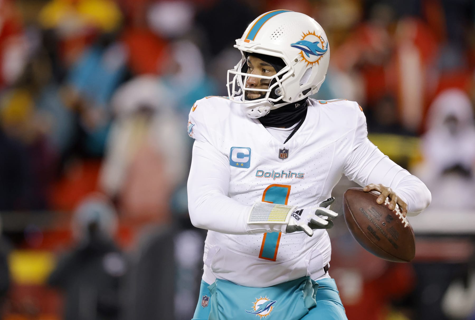KANSAS CITY, MISSOURI - JANUARY 13: Tua Tagovailoa #1 of the Miami Dolphins looks to pass during the first half against the Kansas City Chiefs in the AFC Wild Card Playoffs at GEHA Field at Arrowhead Stadium on January 13, 2024 in Kansas City, Missouri. (Photo by David Eulitt/Getty Images)