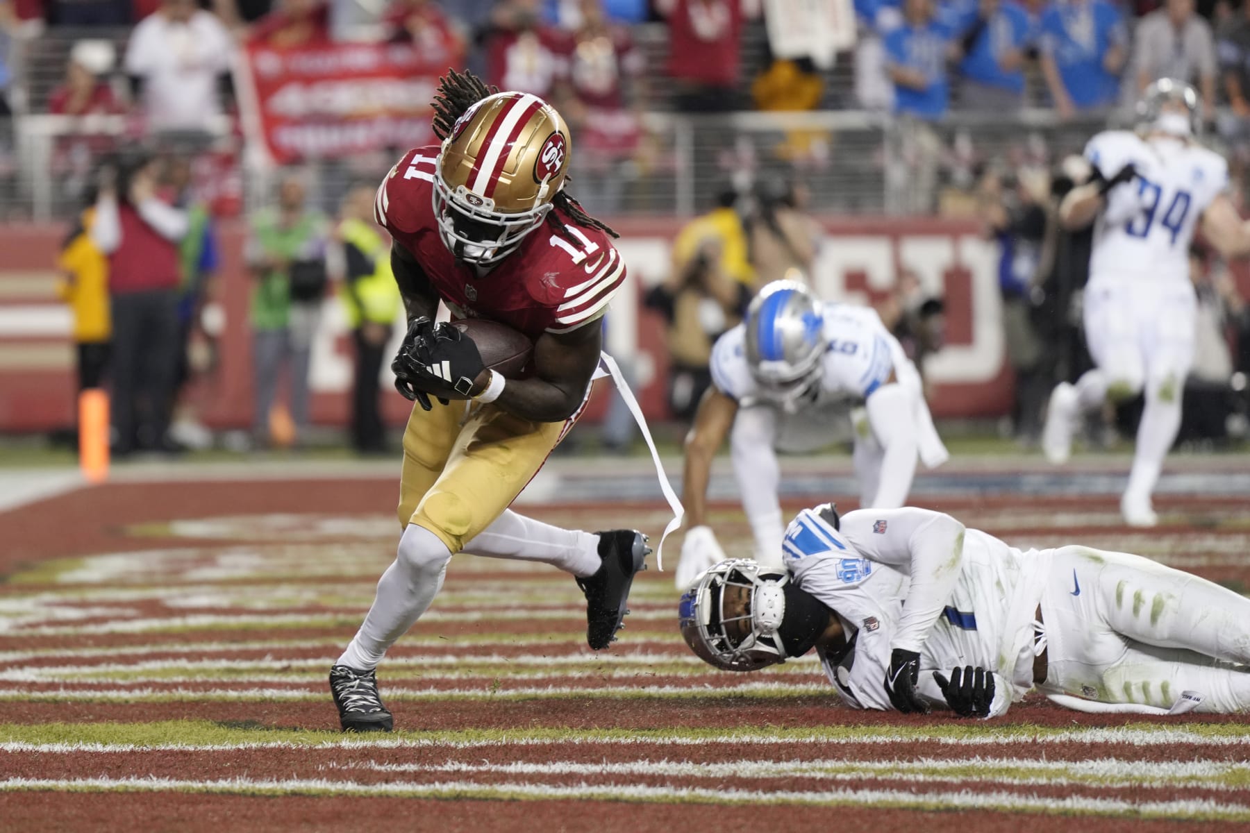 SANTA CLARA, CALIFORNIA - JANUARY 28: Brandon Aiyuk #11 of the San Francisco 49ers catches a pass for a touchdown during the third quarter against the Detroit Lions in the NFC Championship Game at Levi's Stadium on January 28, 2024 in Santa Clara, California. (Photo by Thearon W. Henderson/Getty Images)