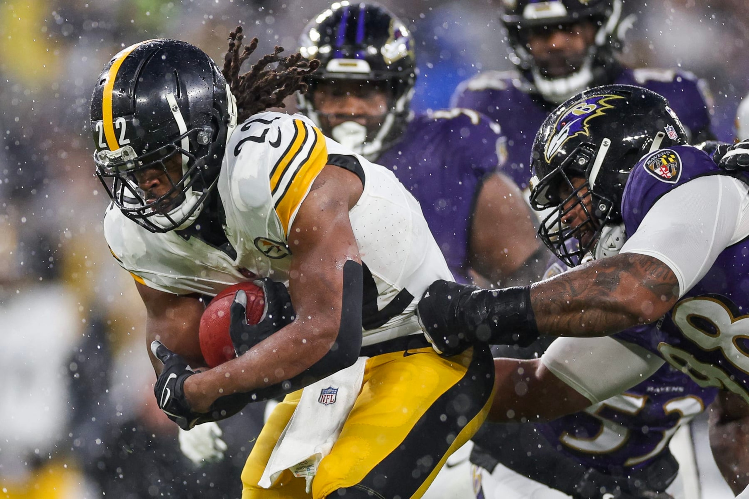 BALTIMORE, MARYLAND - JANUARY 06: Najee Harris #22 of the Pittsburgh Steelers is tackled by Travis Jones #98 of the Baltimore Ravens in the first quarter of a game at M&T Bank Stadium on January 06, 2024 in Baltimore, Maryland. (Photo by Patrick Smith/Getty Images)