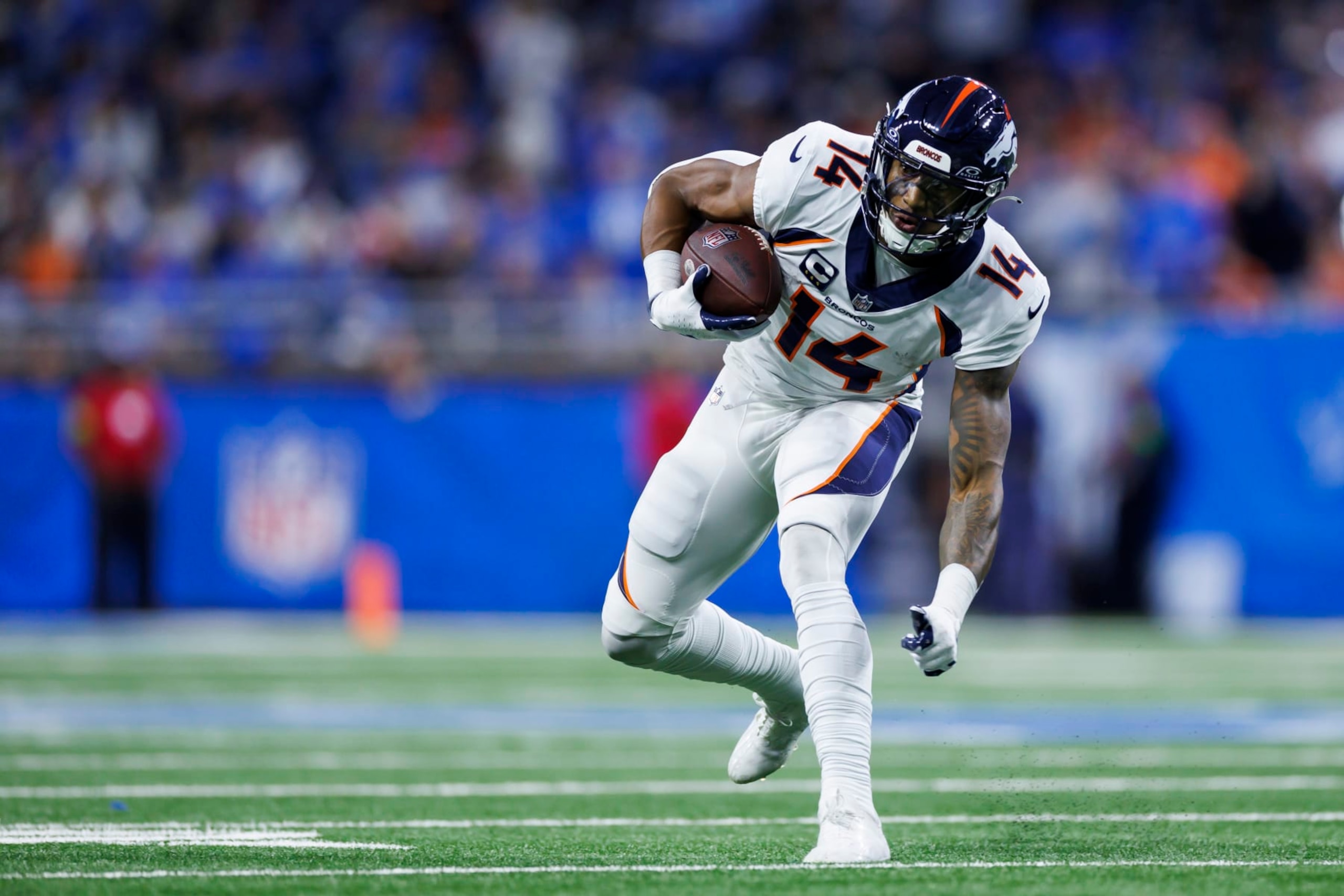 DETROIT, MICHIGAN - DECEMBER 16: Courtland Sutton #14 of the Denver Broncos runs the ball after a catch during an NFL football game against the Detroit Lions at Ford Field on December 16, 2023 in Detroit, Michigan. (Photo by Ryan Kang/Getty Images)