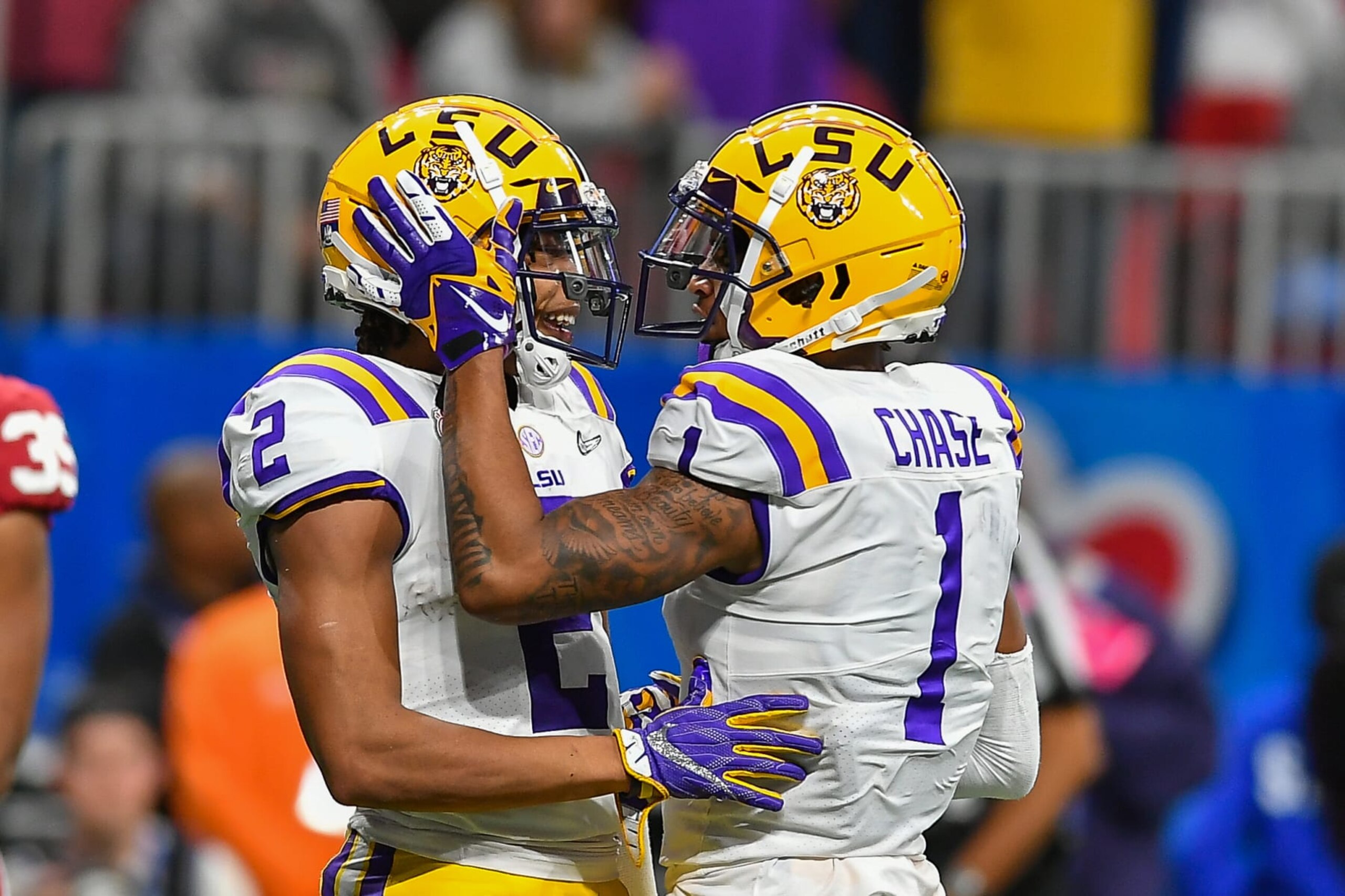 ATLANTA, GA - DECEMBER 28: LSU's Ja'Marr Chase (1) congratulates teammate Justin Jefferson (2) after he caught a touchdown pass during the College Football Playoff Semifinal game between the LSU Tigers and the Oklahoma Sooners on December 28th, 2019 at the Chick-fil-A Peach Bowl in Mercedes-Benz Stadium in Atlanta, GA.  (Photo by Rich von Biberstein/Icon Sportswire via Getty Images)