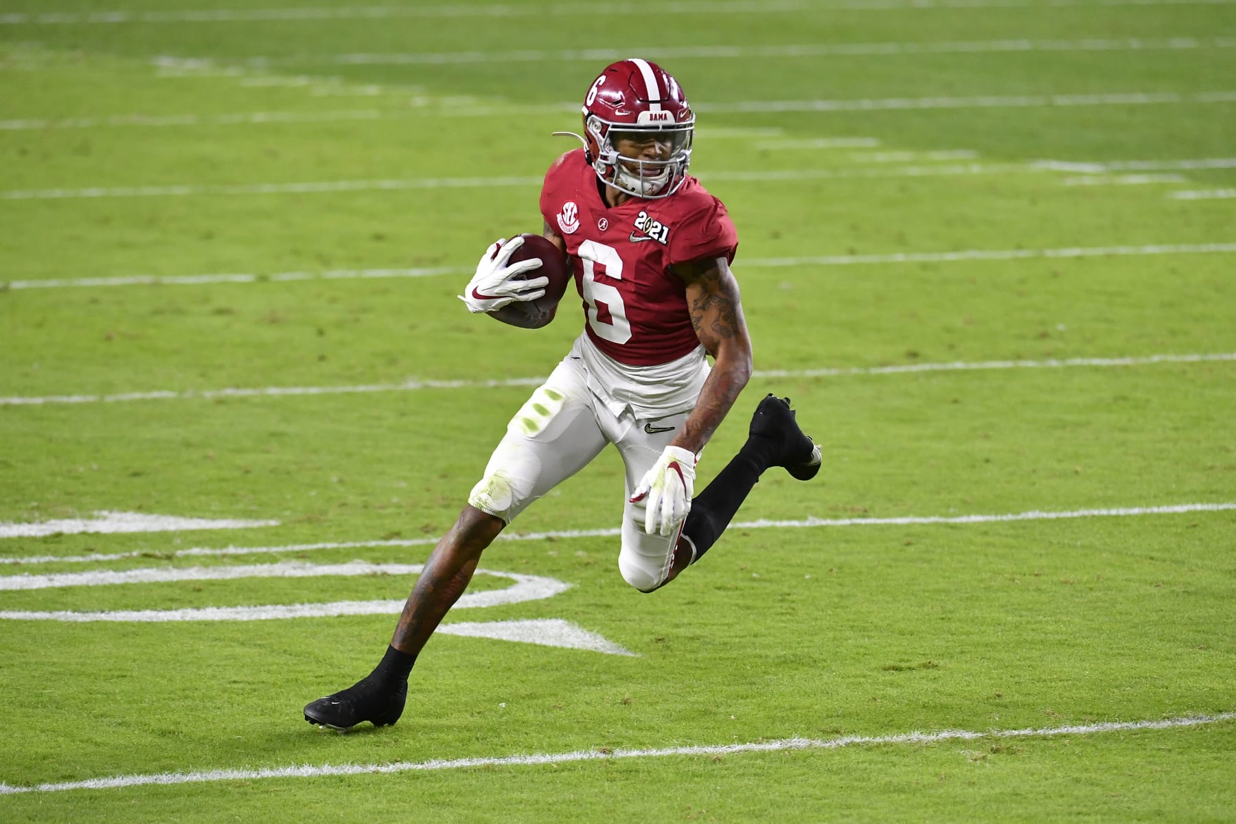 MIAMI GARDENS, FLORIDA - JANUARY 11: DeVonta Smith #6 of the Alabama Crimson Tide runs with the ball during the College Football Playoff National Championship football game against the Ohio State Buckeyes at Hard Rock Stadium on January 11, 2021 in Miami Gardens, Florida. The Alabama Crimson Tide defeated the Ohio State Buckeyes 52-24. (Photo by Alika Jenner/Getty Images)