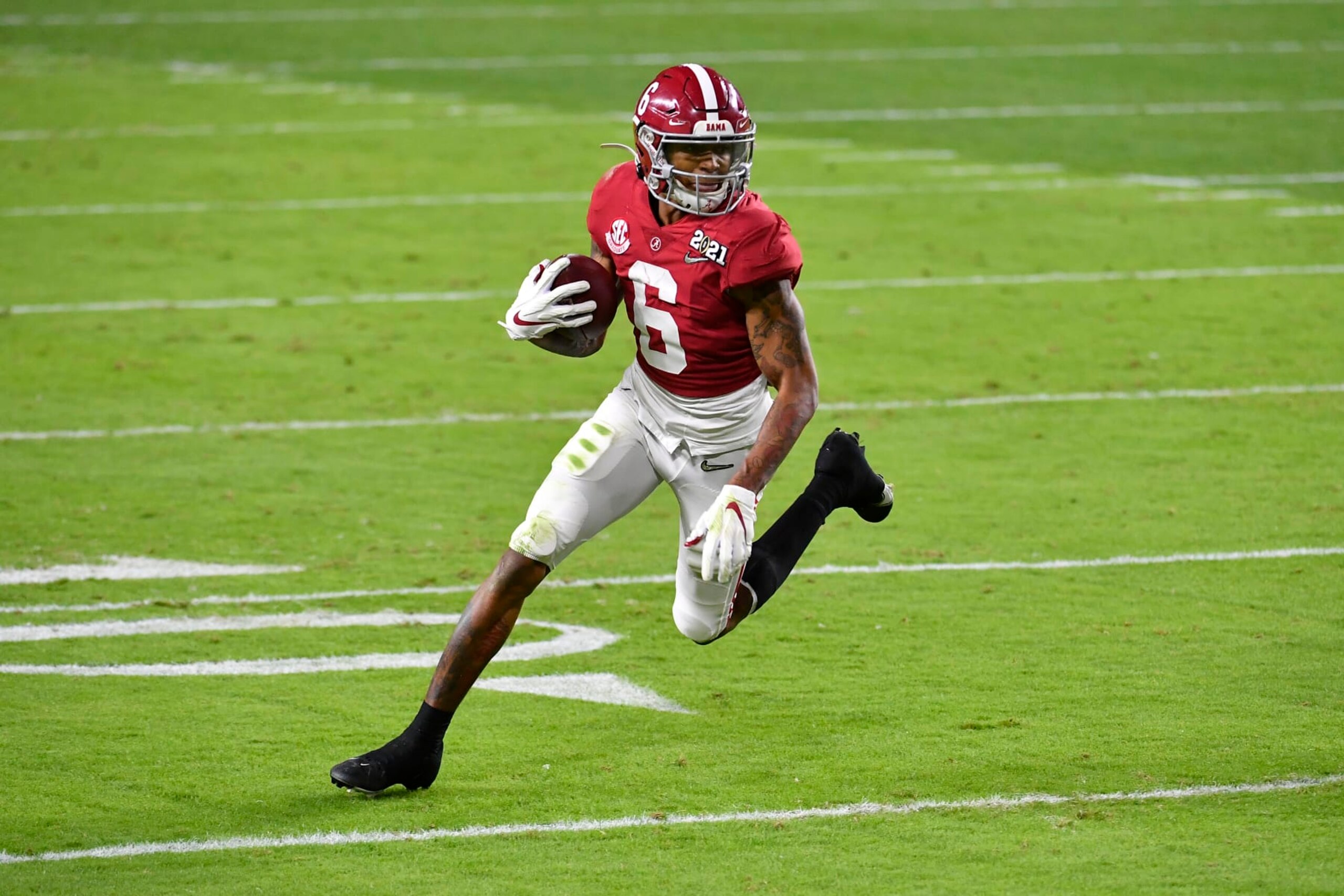 MIAMI GARDENS, FLORIDA - JANUARY 11: DeVonta Smith #6 of the Alabama Crimson Tide runs with the ball during the College Football Playoff National Championship football game against the Ohio State Buckeyes at Hard Rock Stadium on January 11, 2021 in Miami Gardens, Florida. The Alabama Crimson Tide defeated the Ohio State Buckeyes 52-24. (Photo by Alika Jenner/Getty Images)