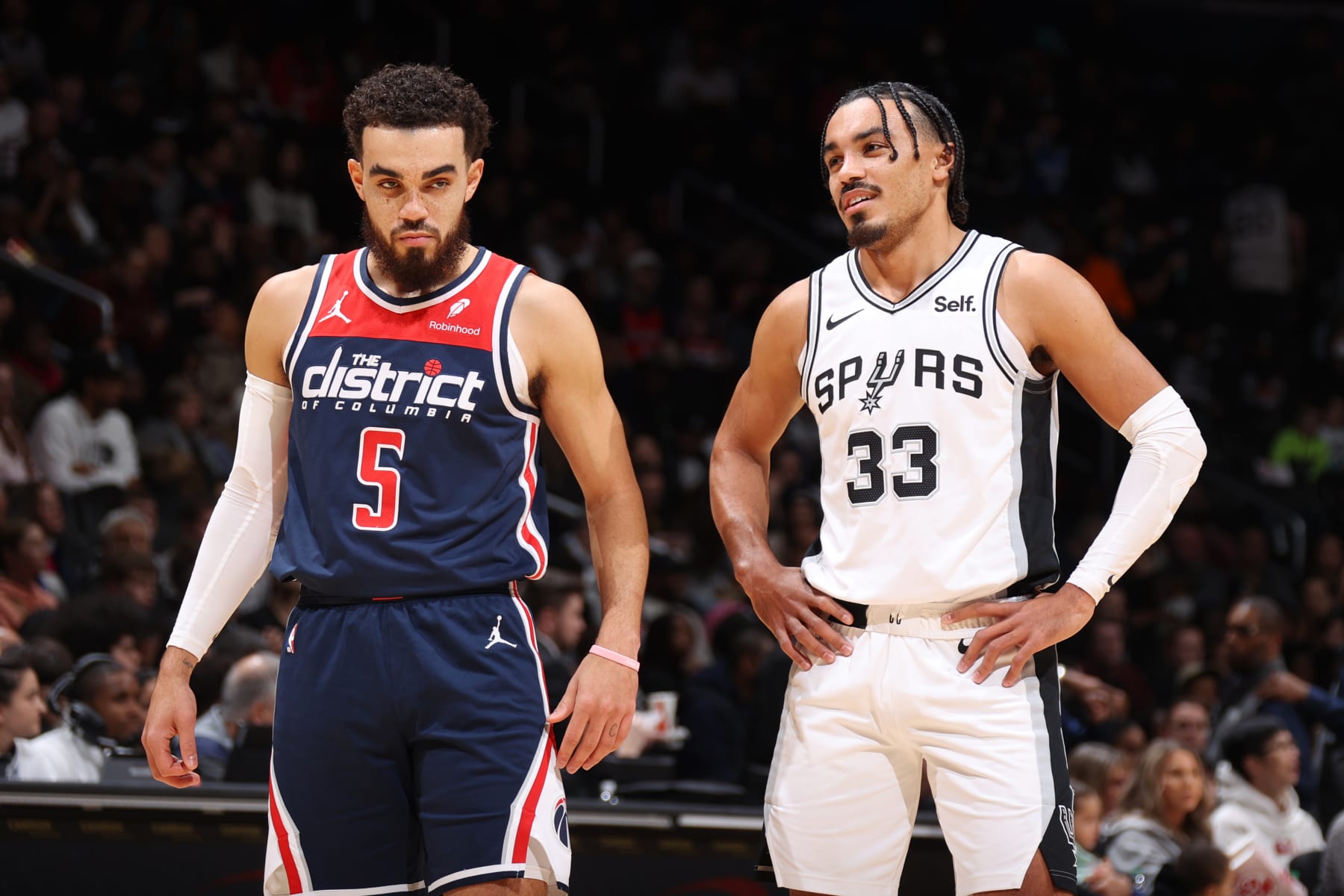 WASHINGTON, DC -  JANUARY 20: Tyus Jones #5 of the Washington Wizards and Tre Jones #33 of the San Antonio Spurs looks on during the game on January 20, 2024 at Capital One Arena in Washington, DC. NOTE TO USER: User expressly acknowledges and agrees that, by downloading and or using this Photograph, user is consenting to the terms and conditions of the Getty Images License Agreement. Mandatory Copyright Notice: Copyright 2024 NBAE (Photo by Stephen Gosling/NBAE via Getty Images)
