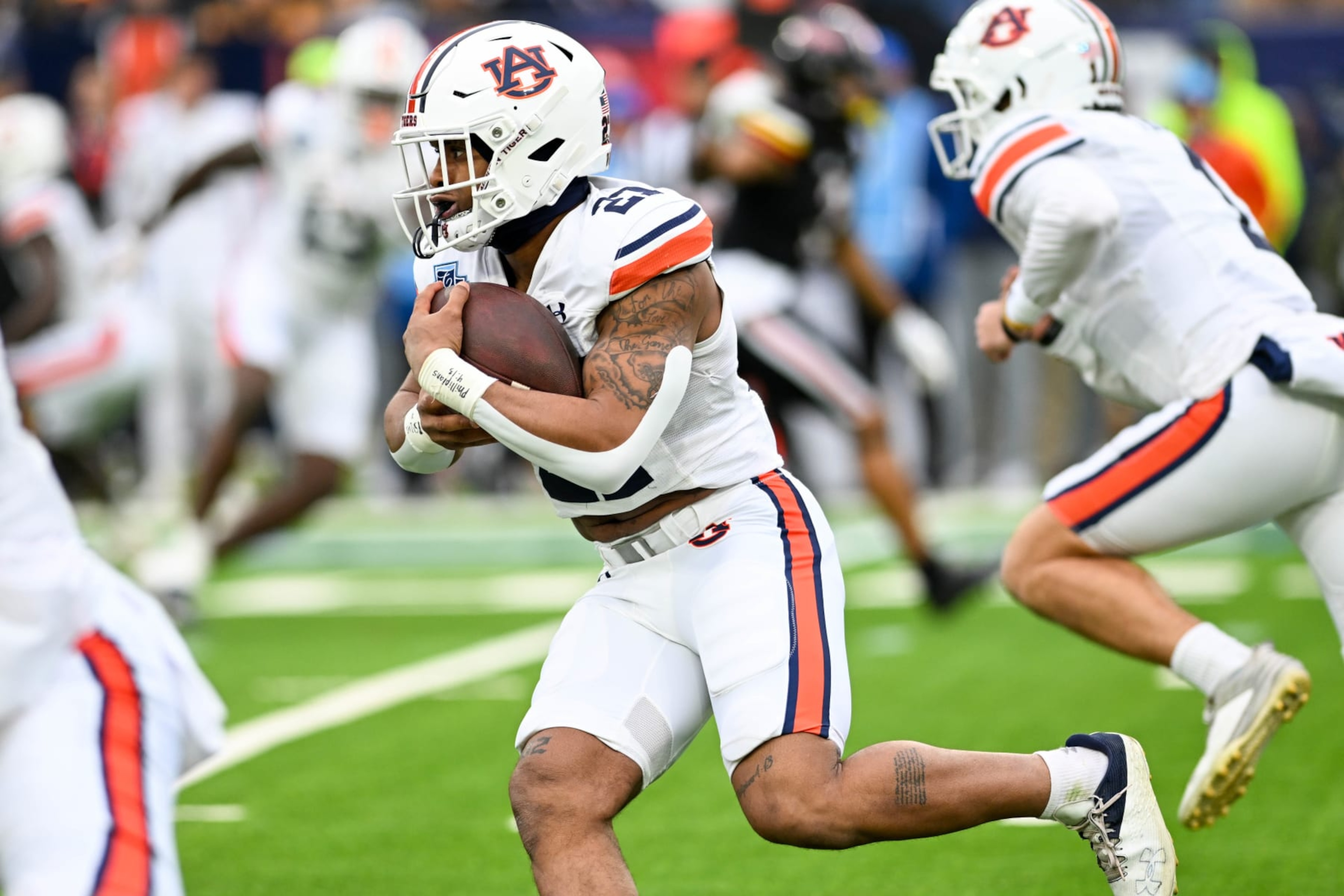 NASHVILLE, TENNESSEE - DECEMBER 30: Brian Battie #21 of the Auburn Tigers runs the ball against the Maryland Terrapins in the first half of the TransPerfect Music City Bowl at Nissan Stadium on December 30, 2023 in Nashville, Tennessee. (Photo by Carly Mackler/Getty Images) NASHVILLE, TENNESSEE - DECEMBER 30: Brian Battie #21 of the Auburn Tigers runs the ball against the Maryland Terrapins in the first half of the TransPerfect Music City Bowl at Nissan Stadium on December 30, 2023 in Nashville, Tennessee. (Photo by Carly Mackler/Getty Images)