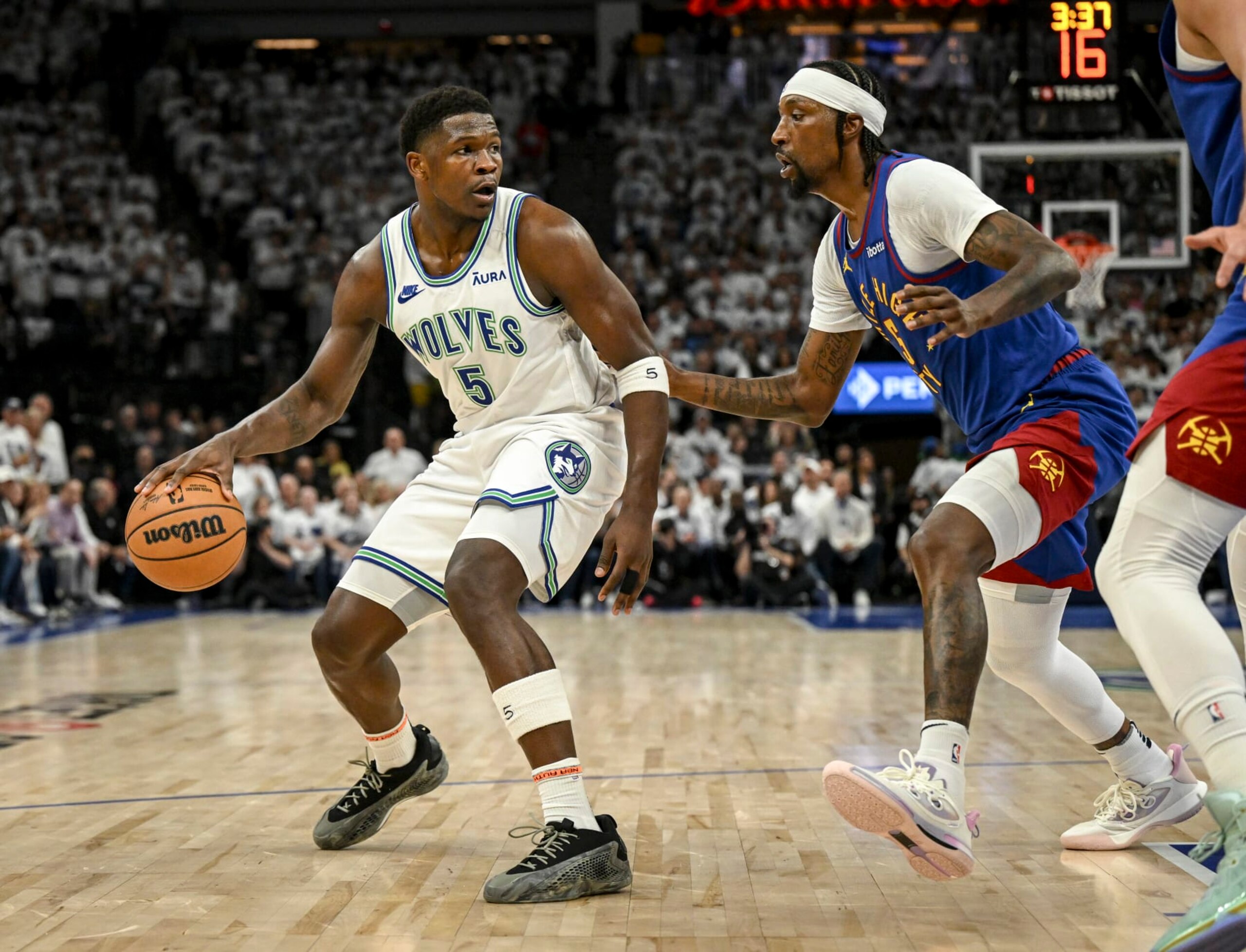 MINNEAPOLIS, MN - MAY 16: Kentavious Caldwell-Pope (5) of the Denver Nuggets defends Anthony Edwards (5) of the Minnesota Timberwolves during the first quarter at Target Center in Minneapolis on Thursday, May 16, 2024. (Photo by AAron Ontiveroz/The Denver Post)