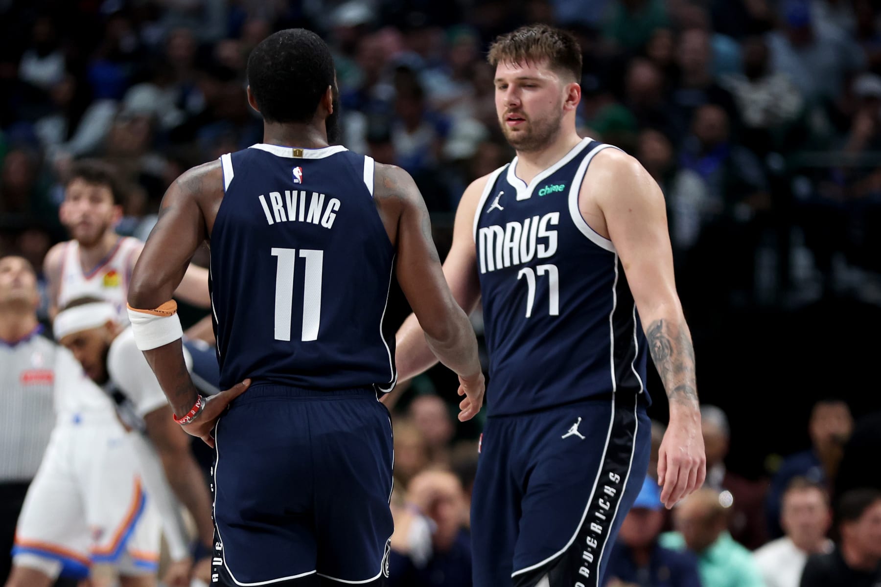 DALLAS, TEXAS - MAY 13: Kyrie Irving #11 of the Dallas Mavericks and Luka Doncic #77 of the Dallas Mavericks talk during a time out against the Oklahoma City Thunder in Game Four of the Western Conference Second Round Playoffs at American Airlines Center on May 11, 2024 in Dallas, Texas. NOTE TO USER: User expressly acknowledges and agrees that, by downloading and or using this photograph, User is consenting to the terms and conditions of the Getty Images License Agreement. (Photo by Tim Heitman/Getty Images)