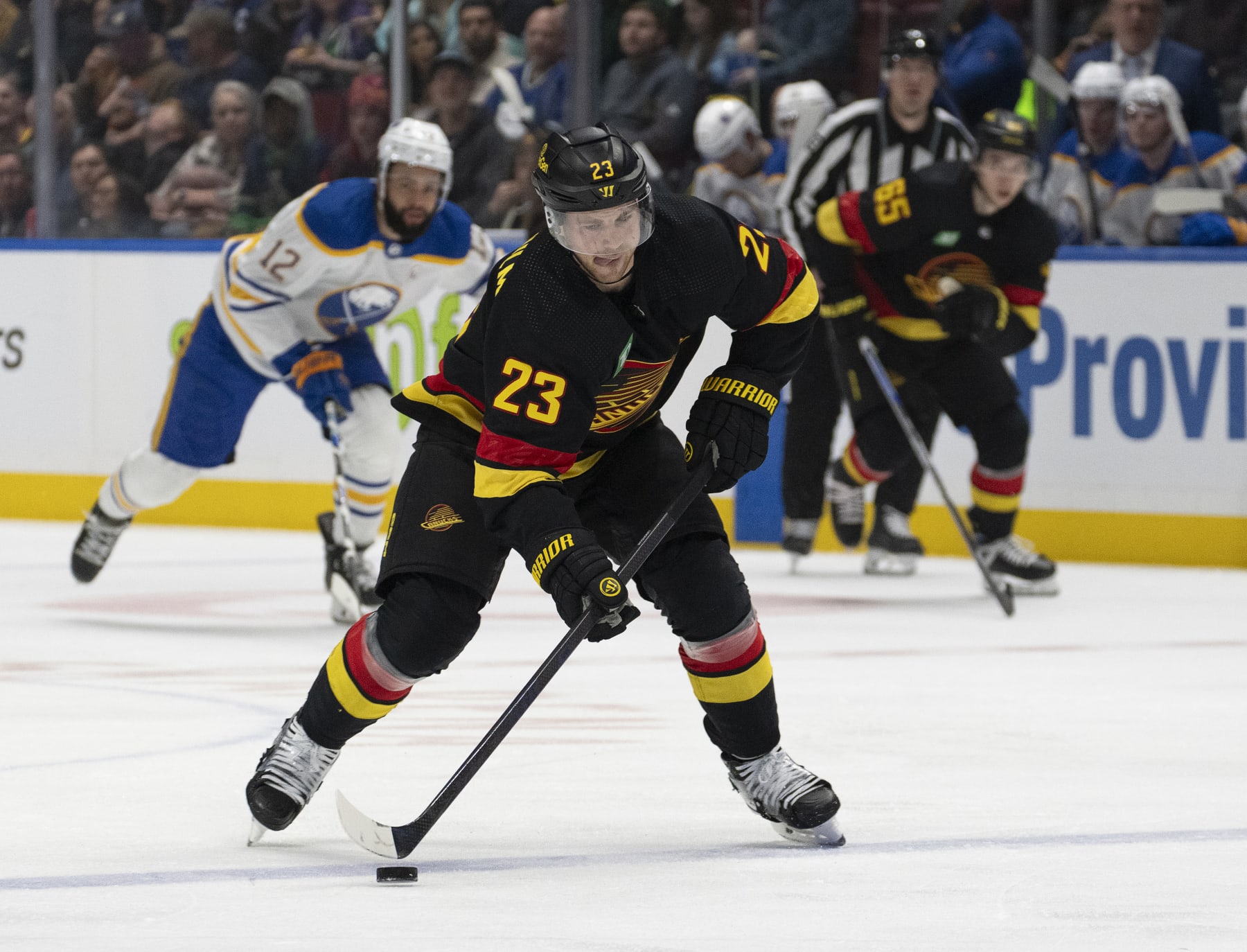 VANCOUVER, CANADA - MARCH 19: Elias Lindholm #23 of the Vancouver Canucks skates up ice during their NHL game against the Buffalo Sabres at Rogers Arena on March 19, 2024 in Vancouver, British Columbia, Canada.  (Photo by Jeff Vinnick/NHLI via Getty Images)