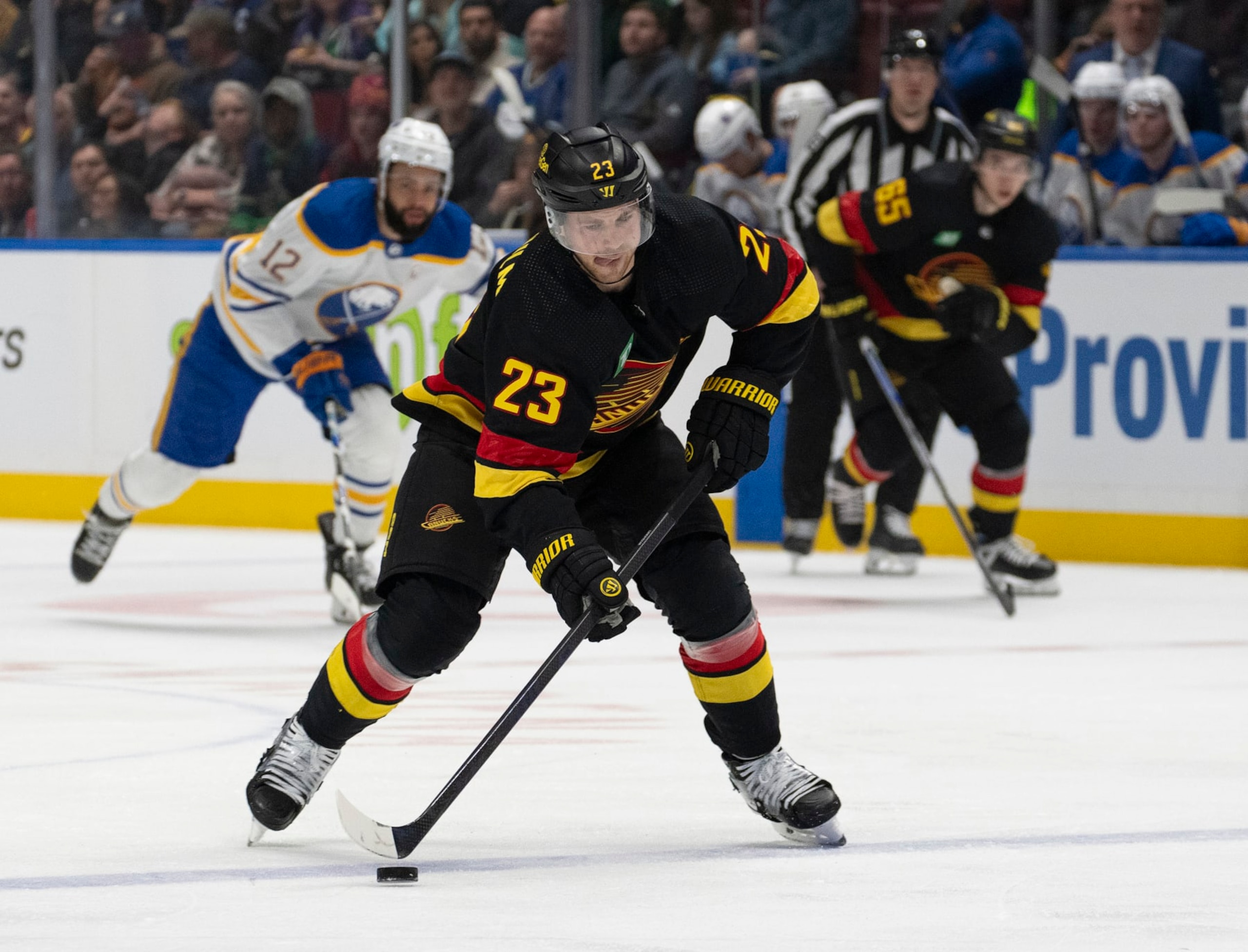 VANCOUVER, CANADA - MARCH 19: Elias Lindholm #23 of the Vancouver Canucks skates up ice during their NHL game against the Buffalo Sabres at Rogers Arena on March 19, 2024 in Vancouver, British Columbia, Canada.  (Photo by Jeff Vinnick/NHLI via Getty Images)
